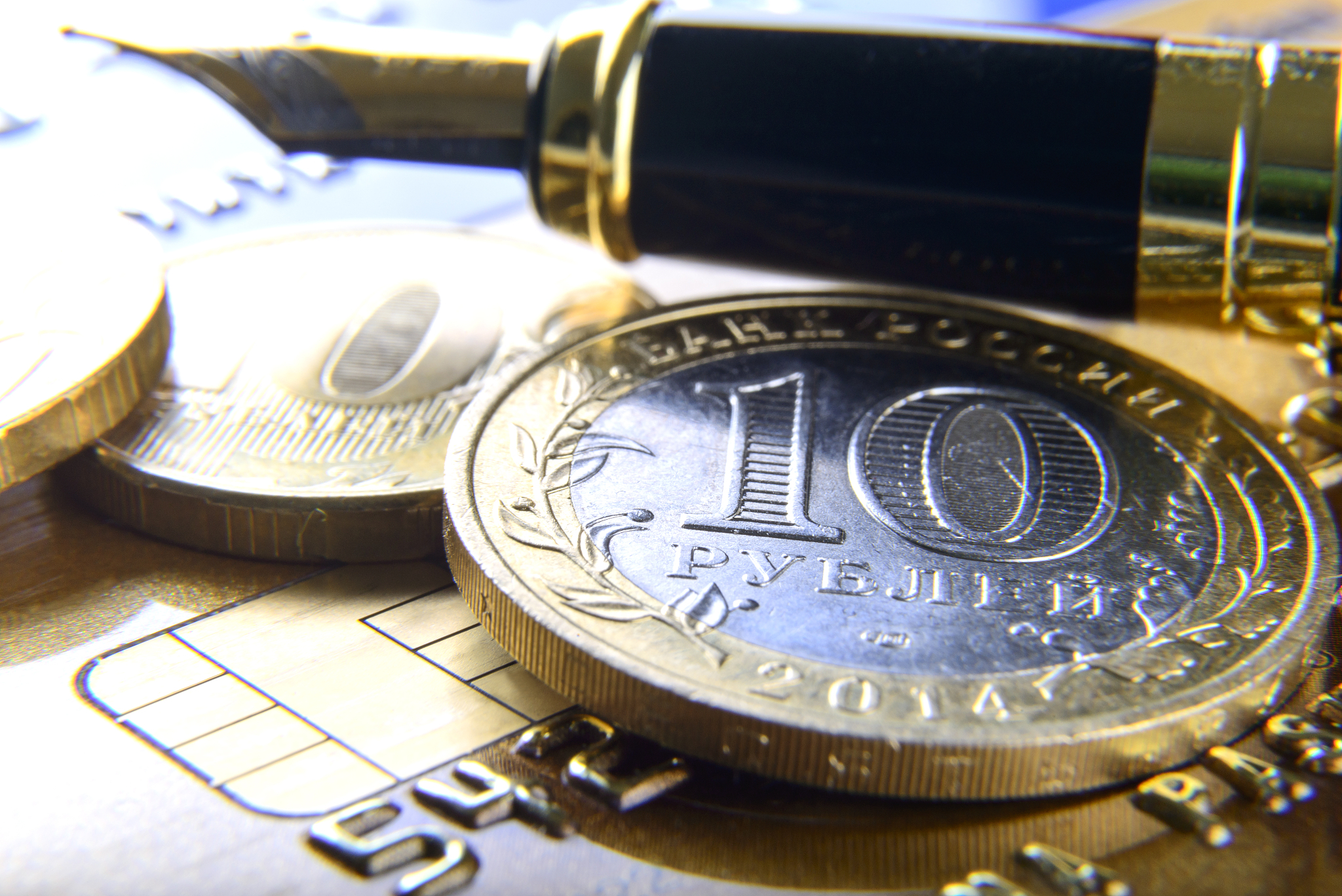 pen and coins on a bank card