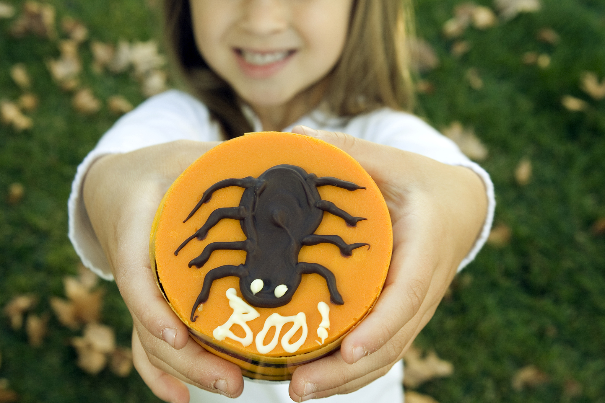 girl holding halloween themed dessert