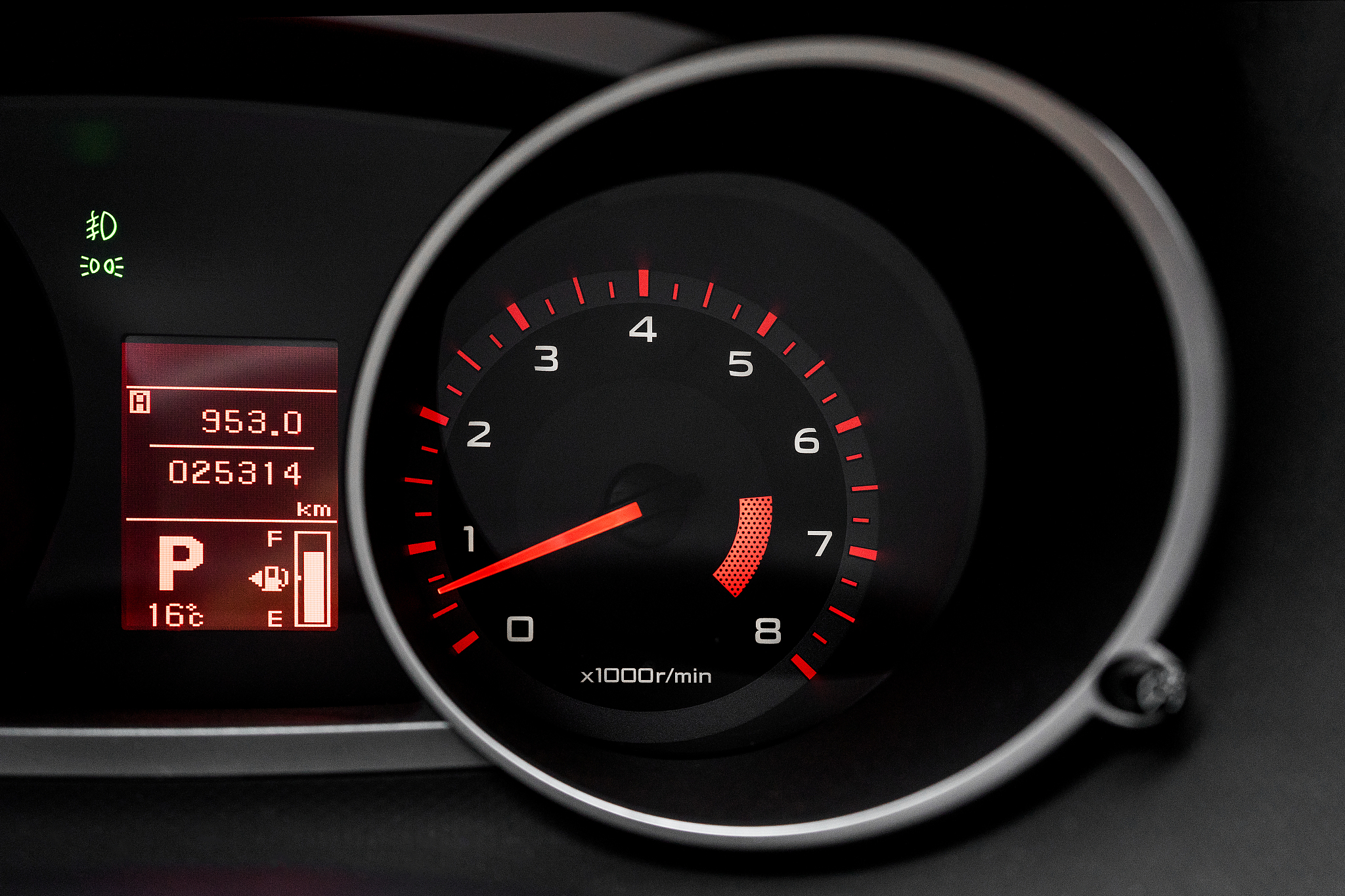 car dashboard with speedometer and illuminated fuel consumption 