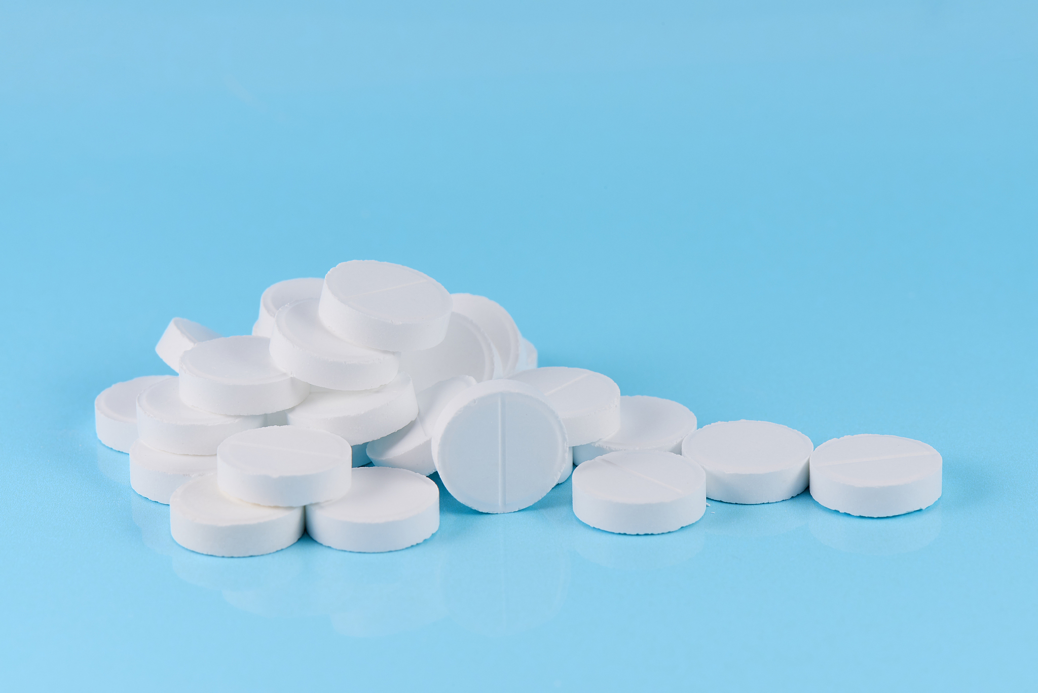 white pills on a blue background.