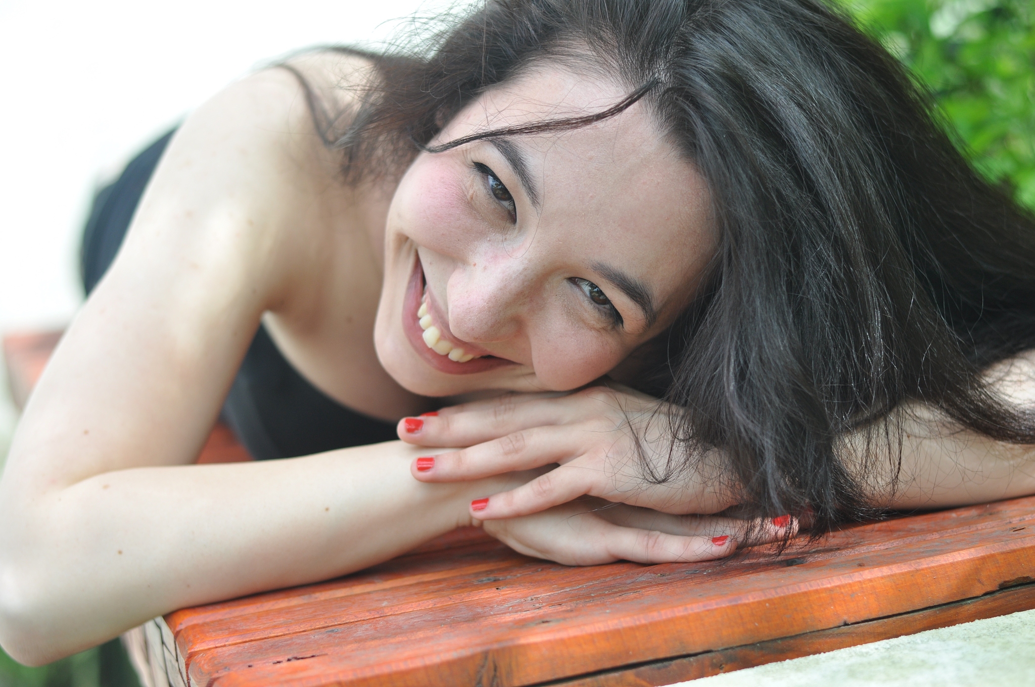 portrait of smiling young woman with black hair