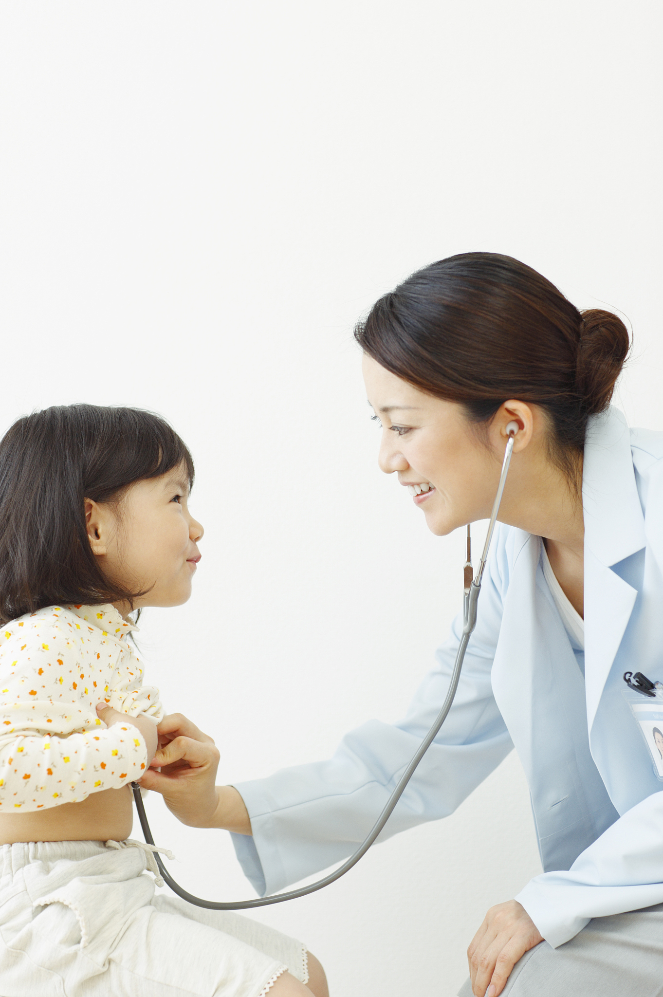 female doctor examining girl, side view