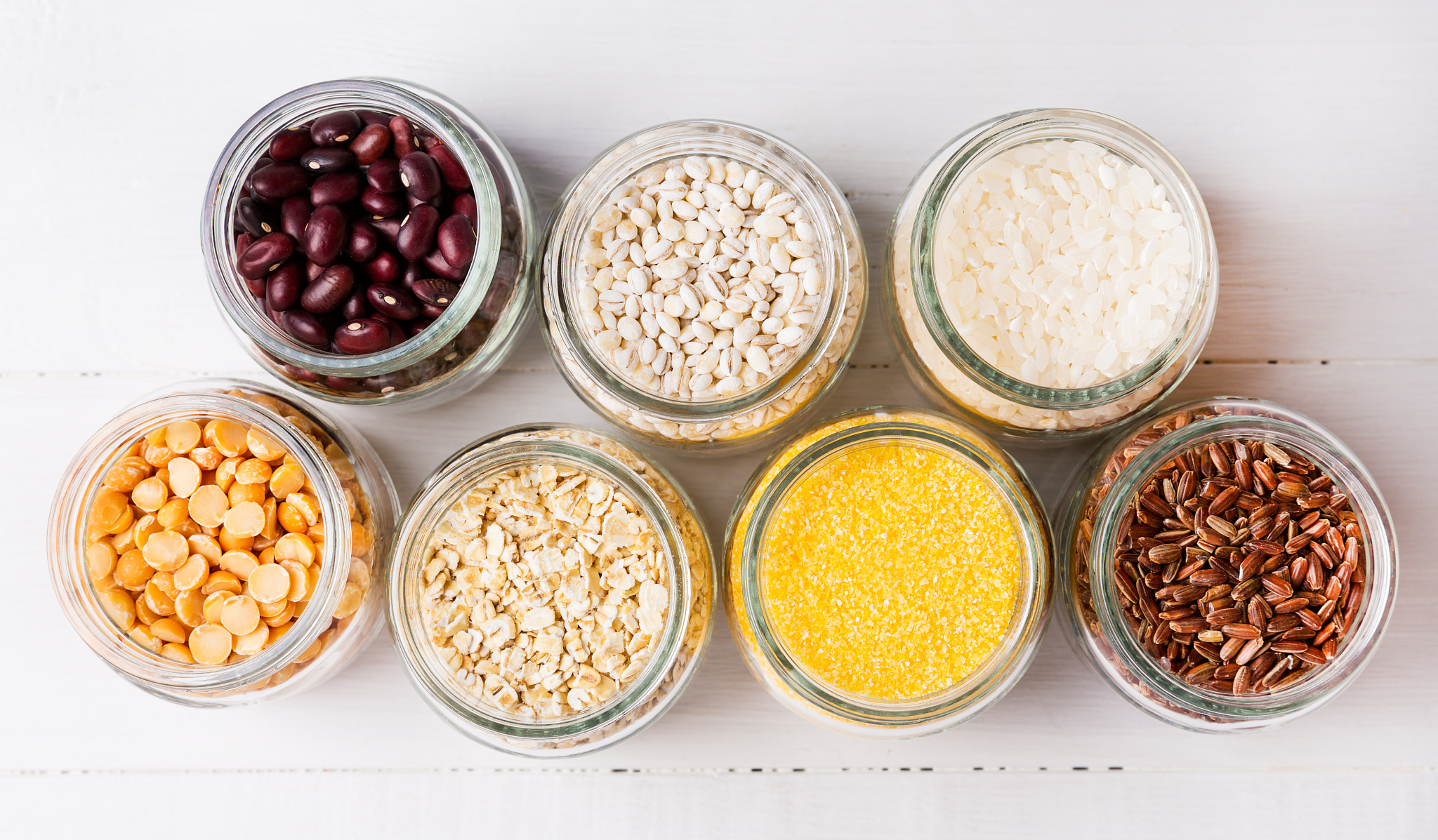 cereals and grains on white wooden background. flat lay, top vie