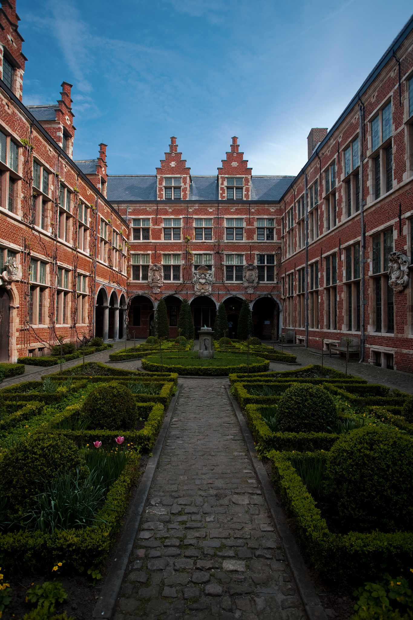 manicured european garden courtyard antwerp vertical