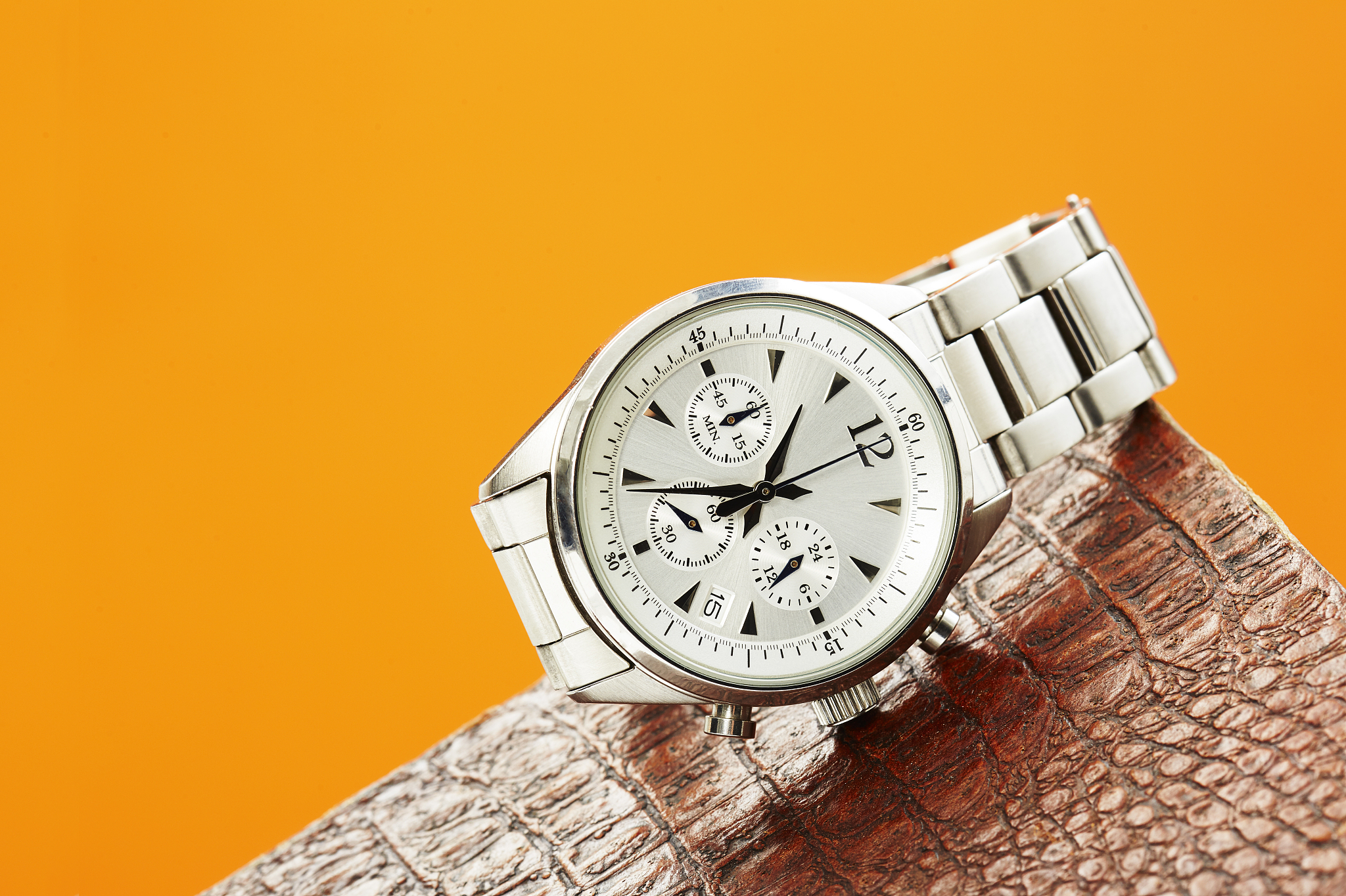 luxury men's watch against colored background
