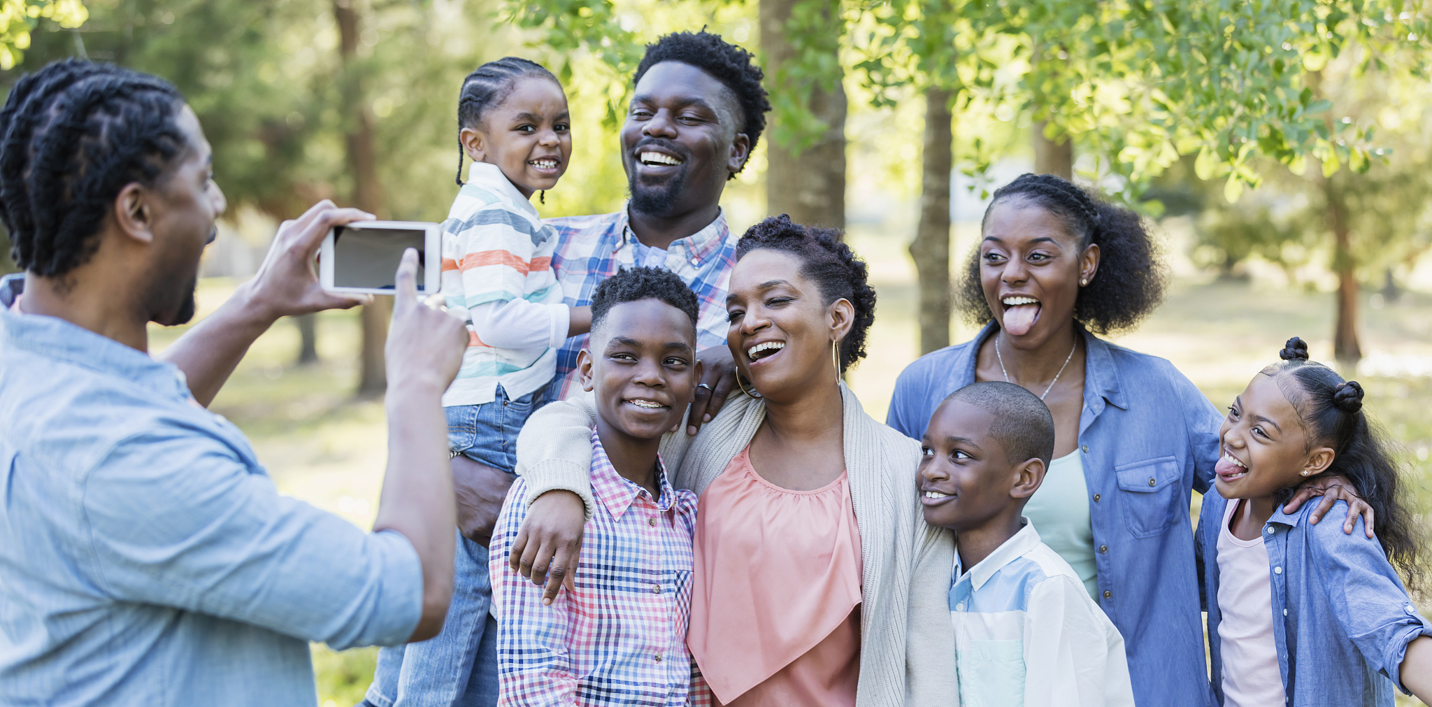 large african-american family, taking photo with phone