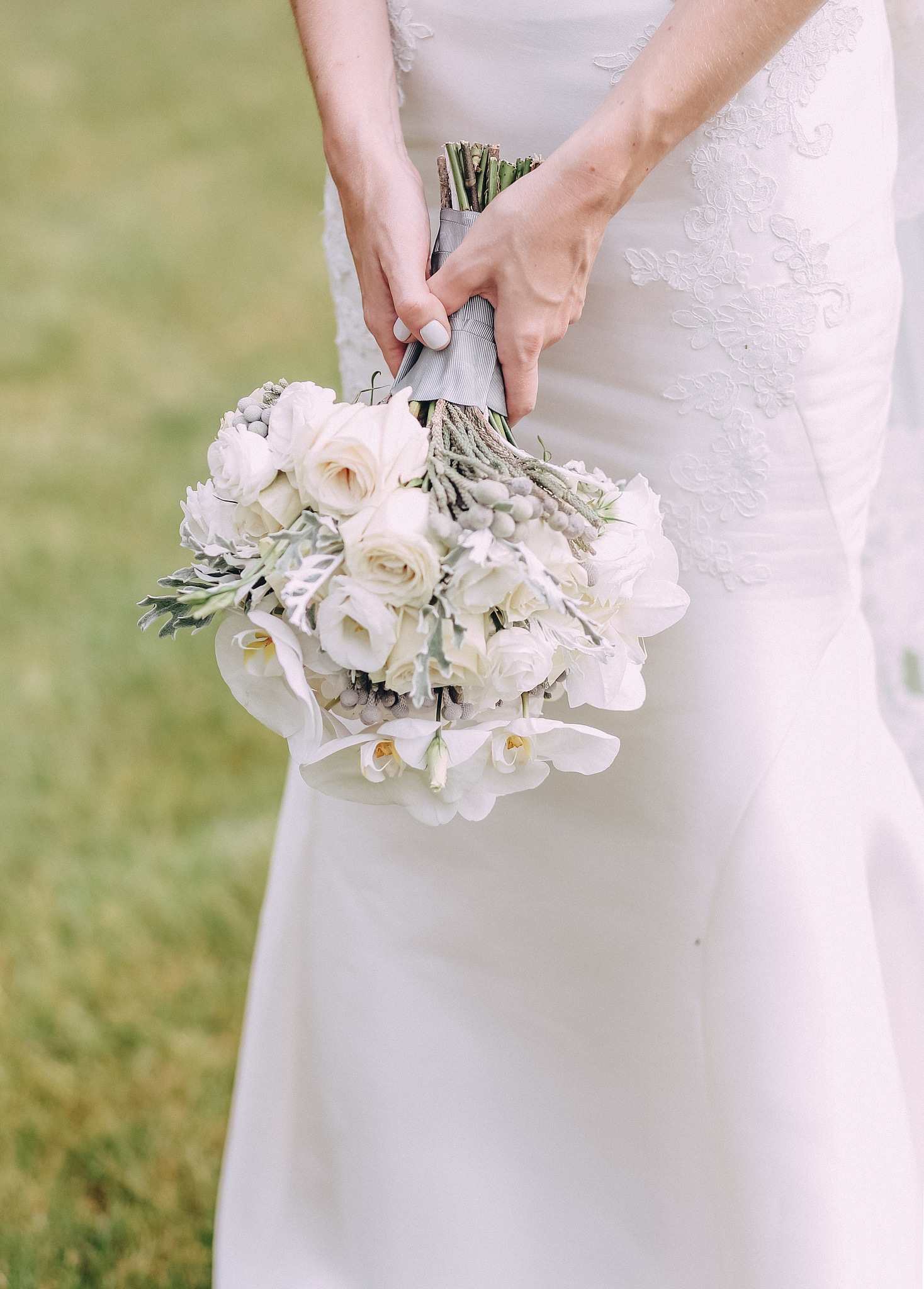 bride holding bouquet white flowers hands down