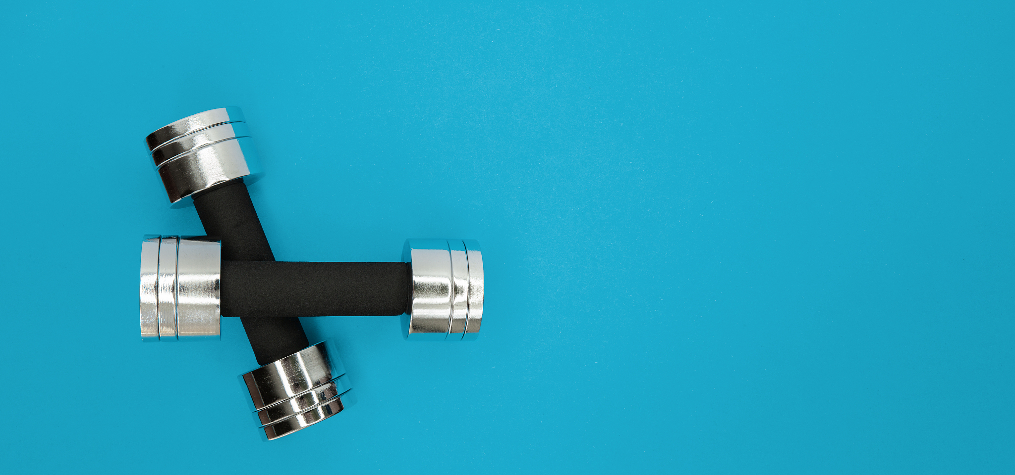 metal small dumbbells on a blue background.