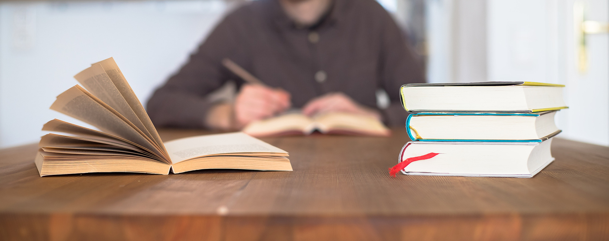 learning and studying concept. stack of books in foreground, you