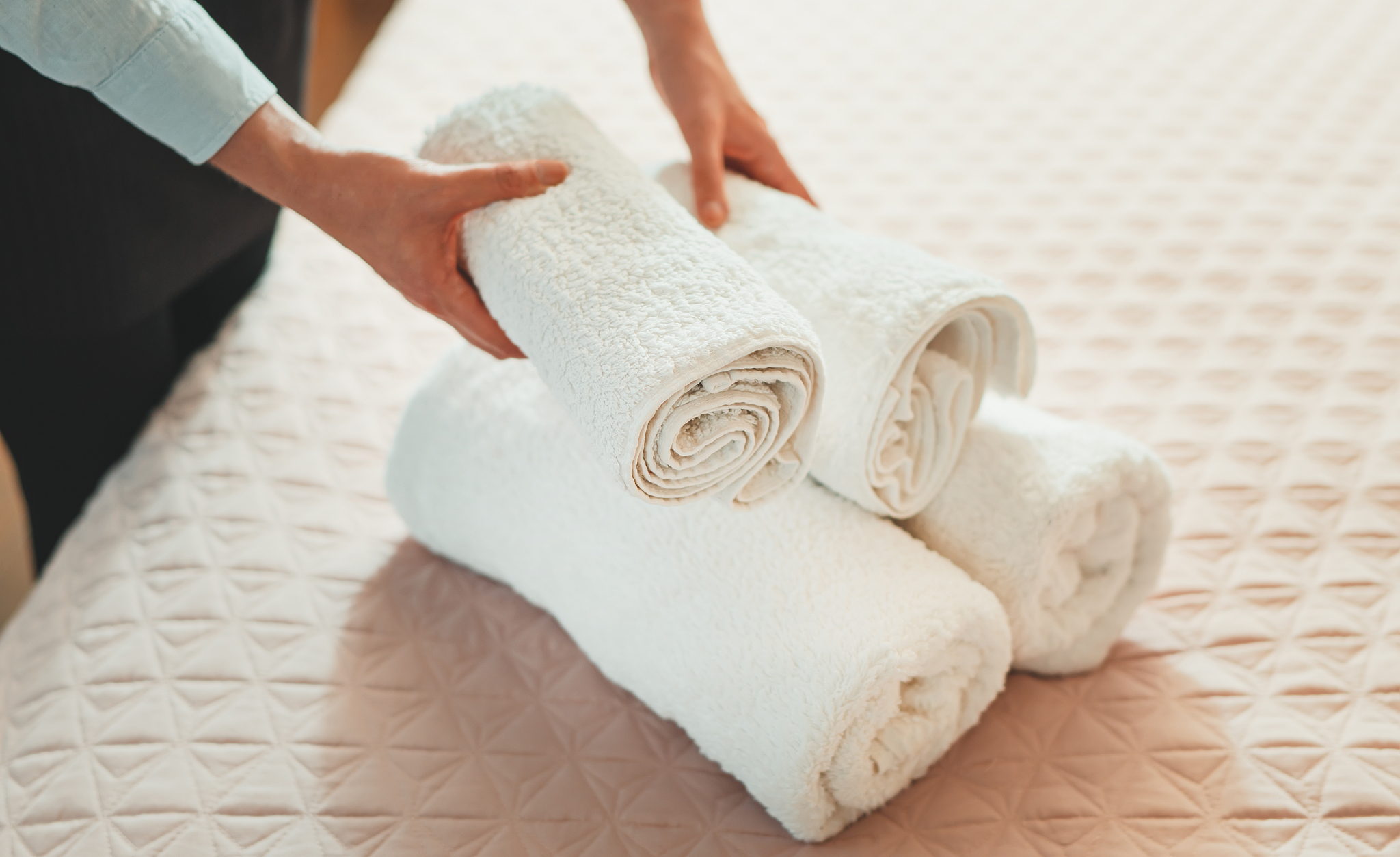 room service. woman changing towels in hotel room.
