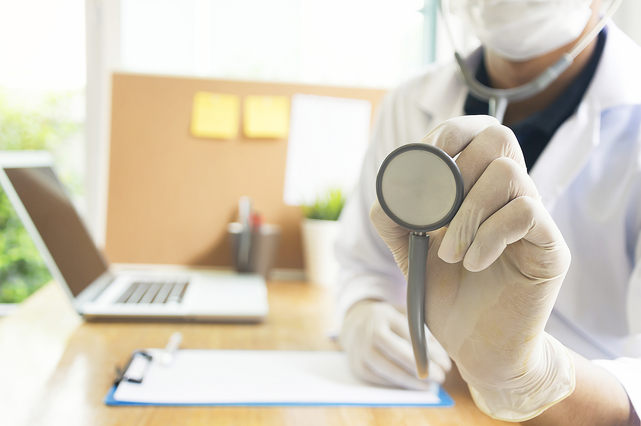 man doctor with a stethoscope in the hands.hospital background.