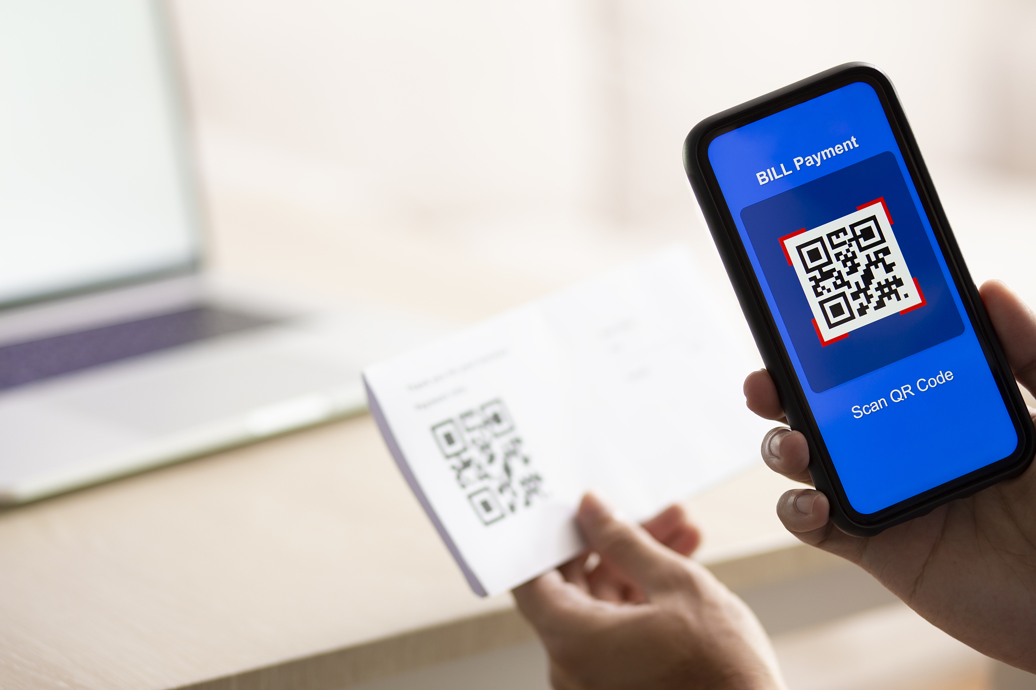 using smartphone scanning qr code for bill payment option