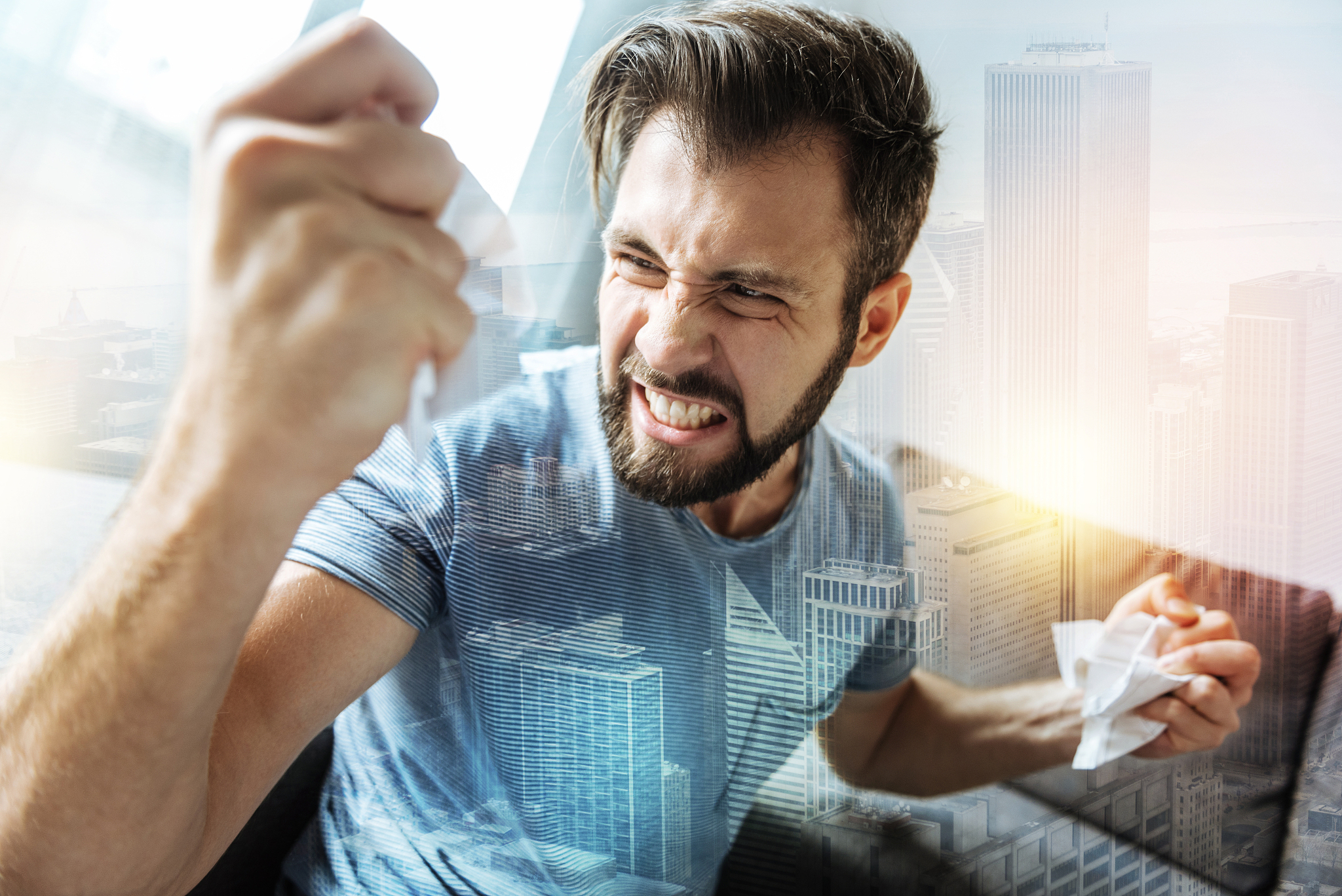 beardful snappish man tearing the paper and feeling bad himself