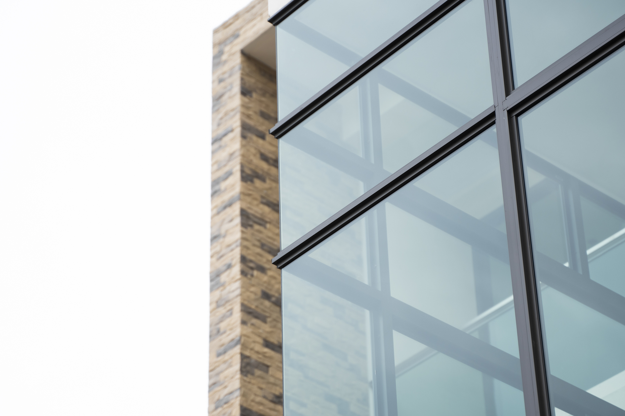 windows of modern apartment buildings exteriors in cloudy day.