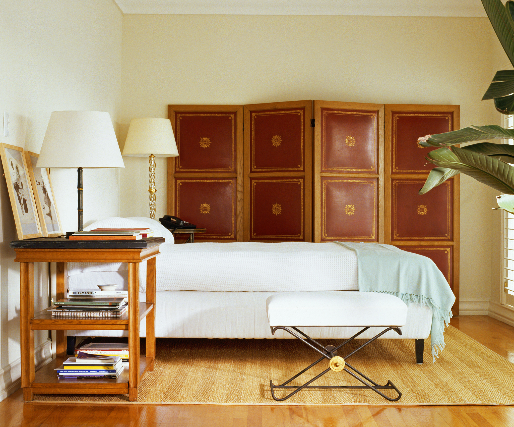 side view of a cozy bed with nightstands on each side