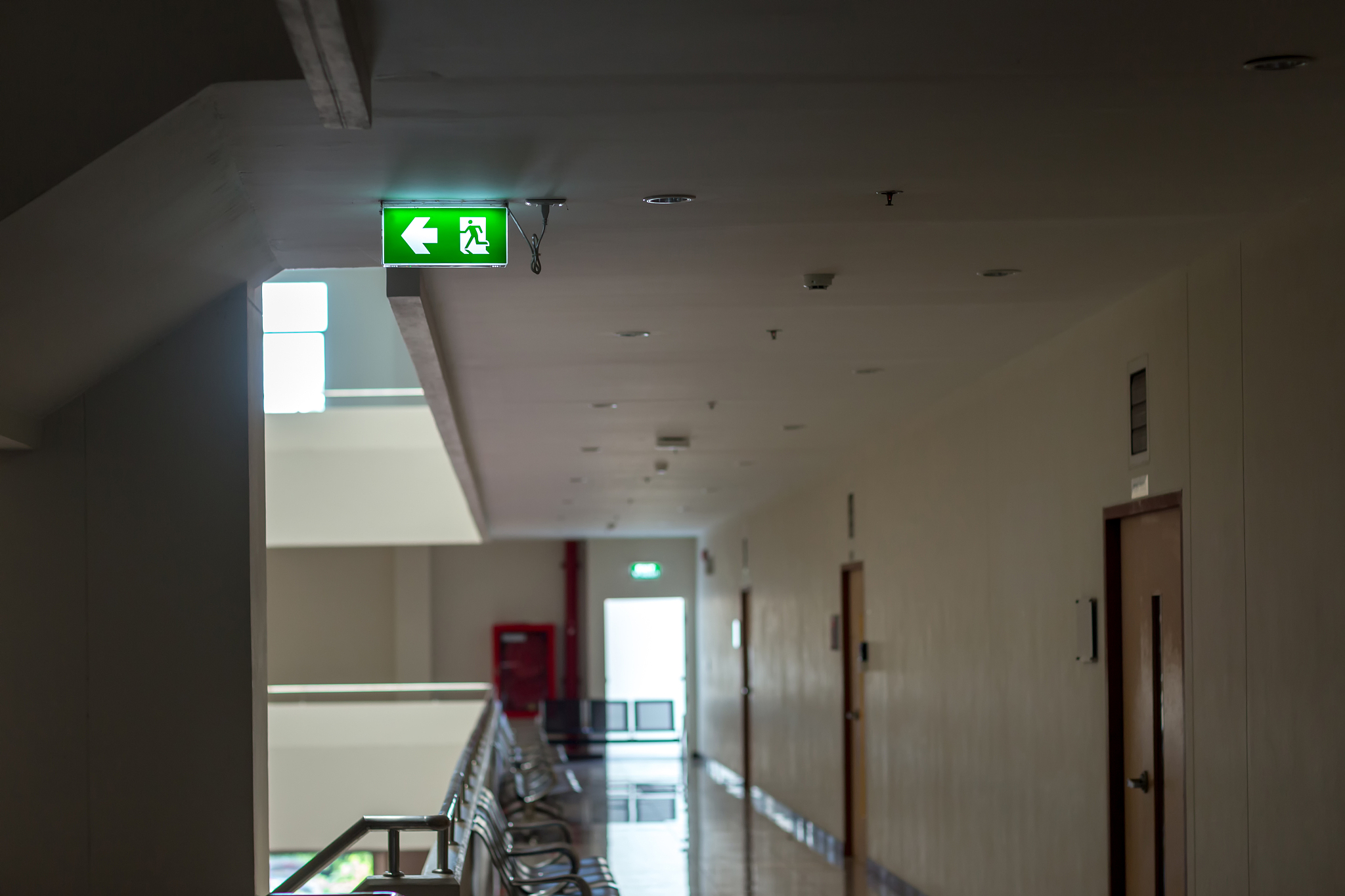 green emergency exit sign showing the way to escape.fire exit in
