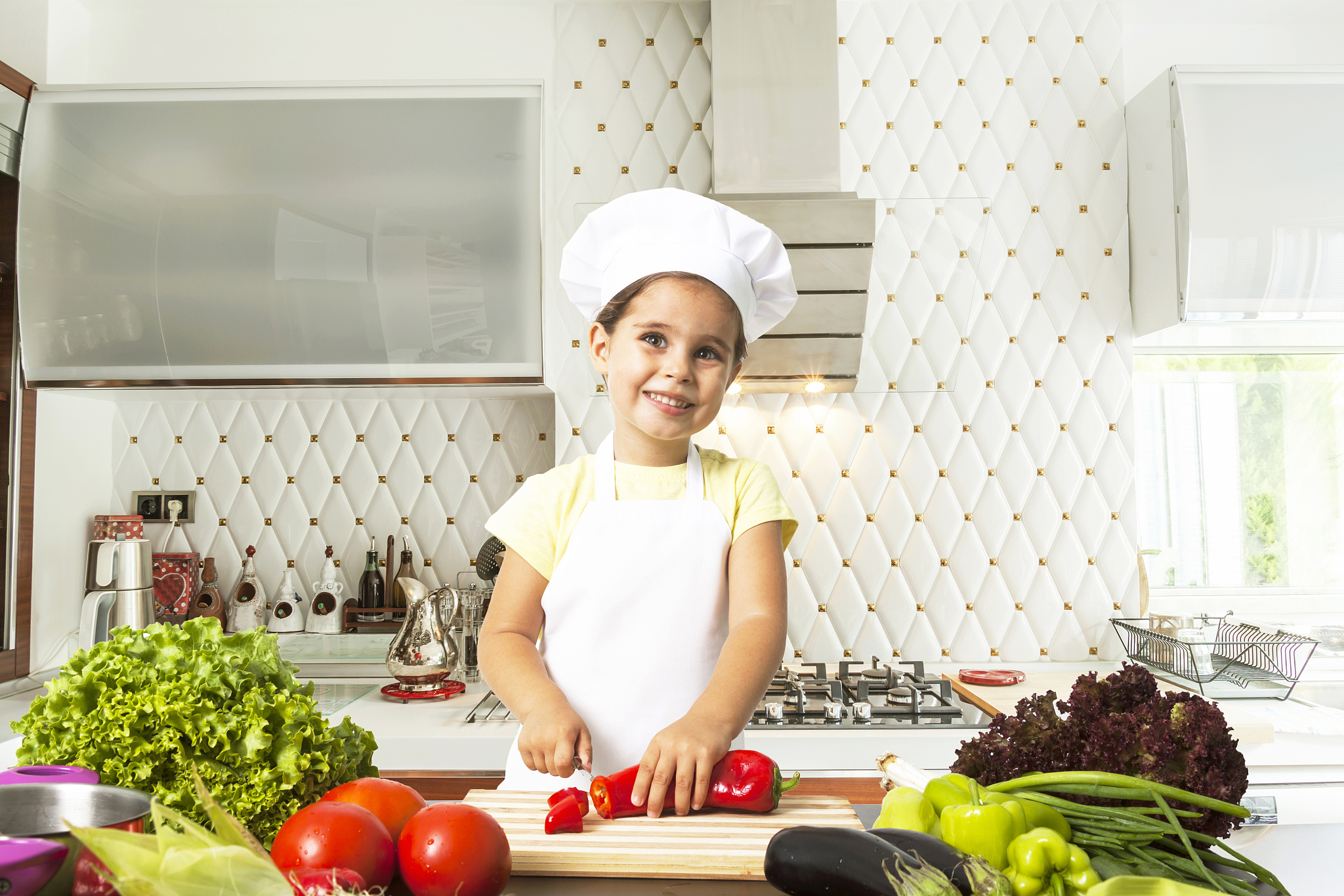 little girl chef preparing cook in kitchen