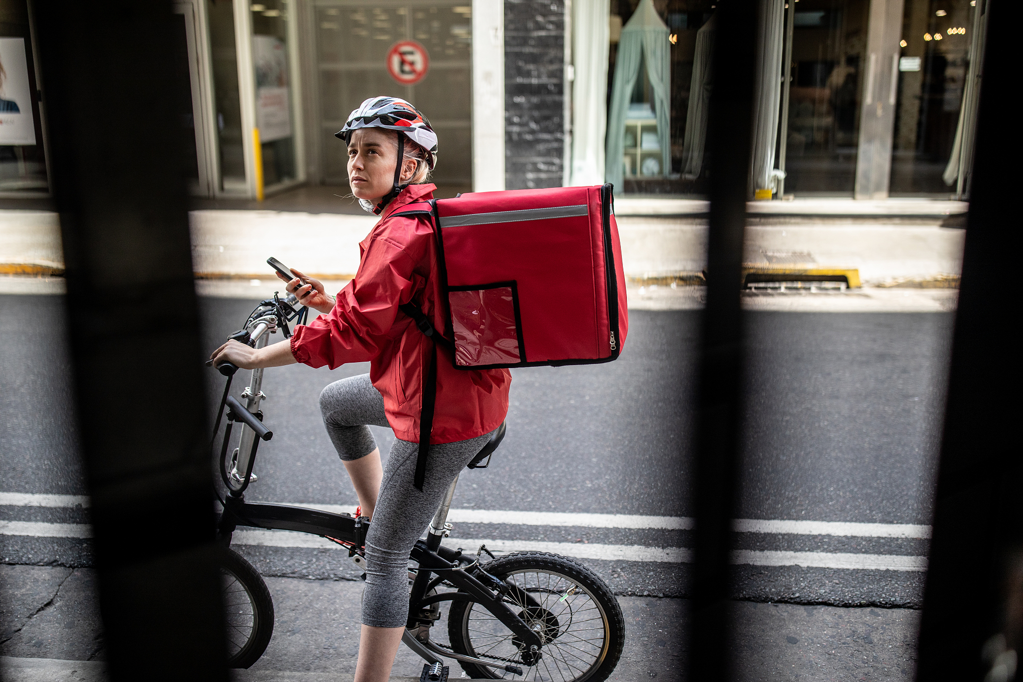 bicycle delivery woman checking directions on smartphone