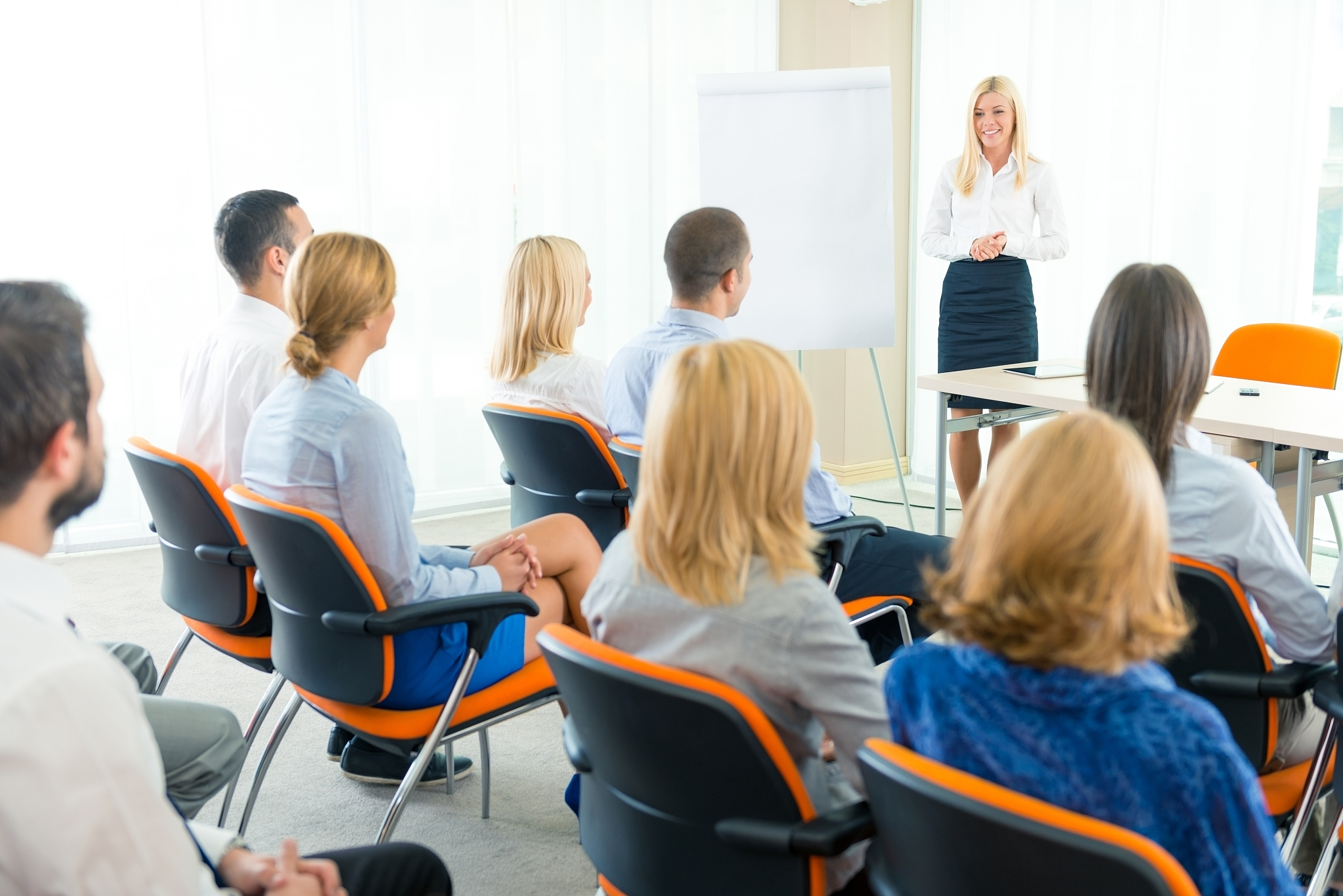 businesswoman standing in front of whiteboard during a meeting