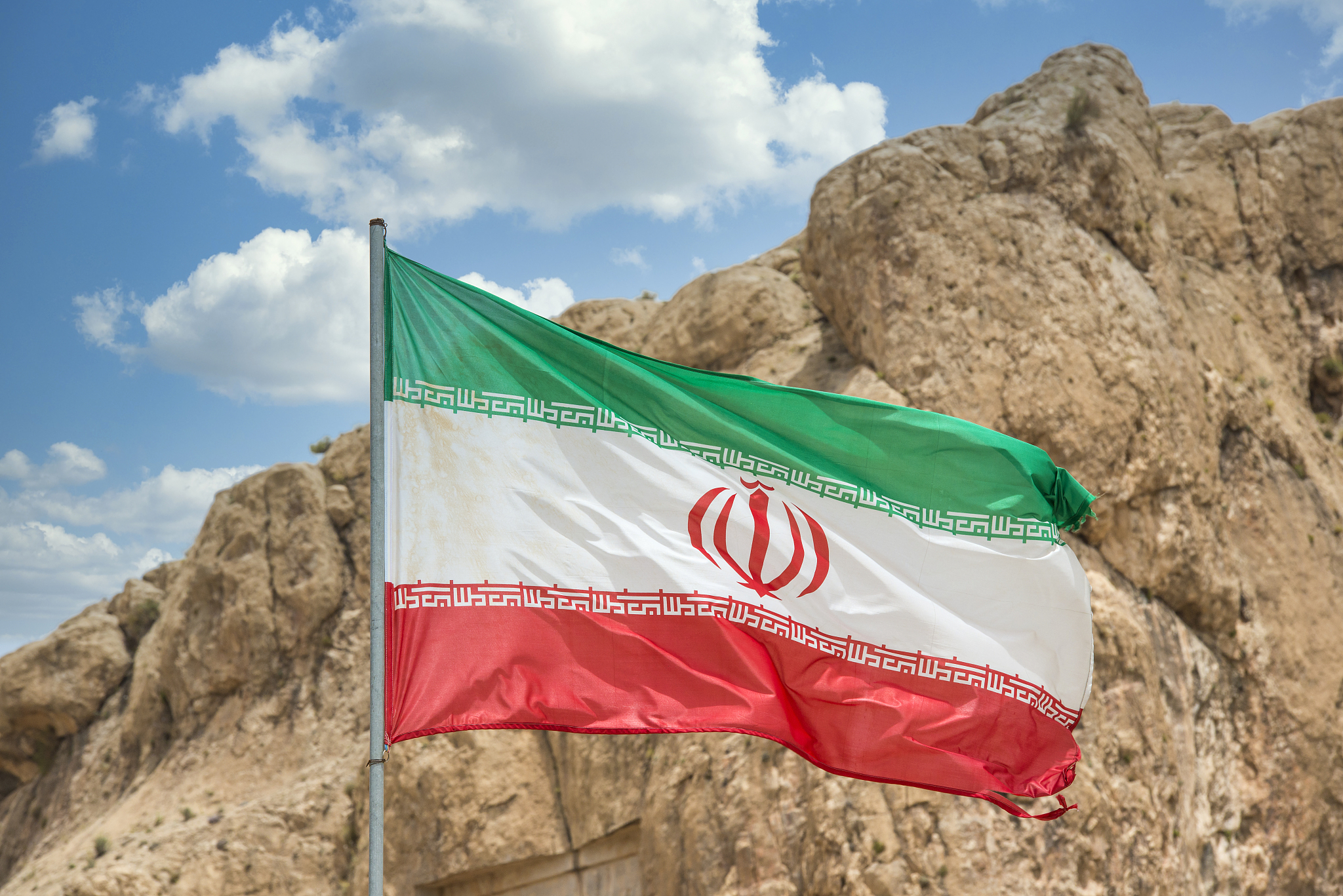 flag of iran in front of persepolis