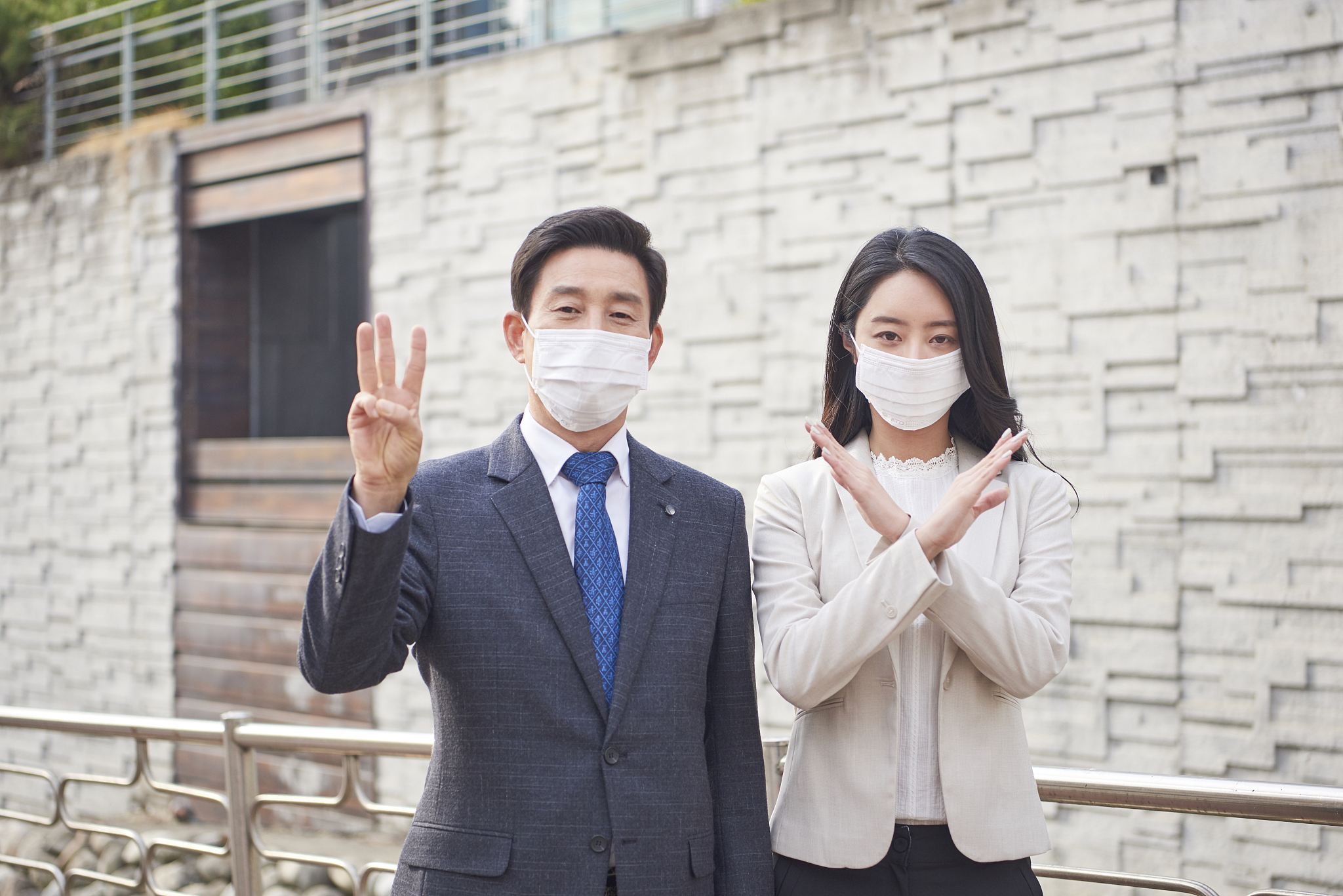businessman and woman with pollution mask standing outdoor with 