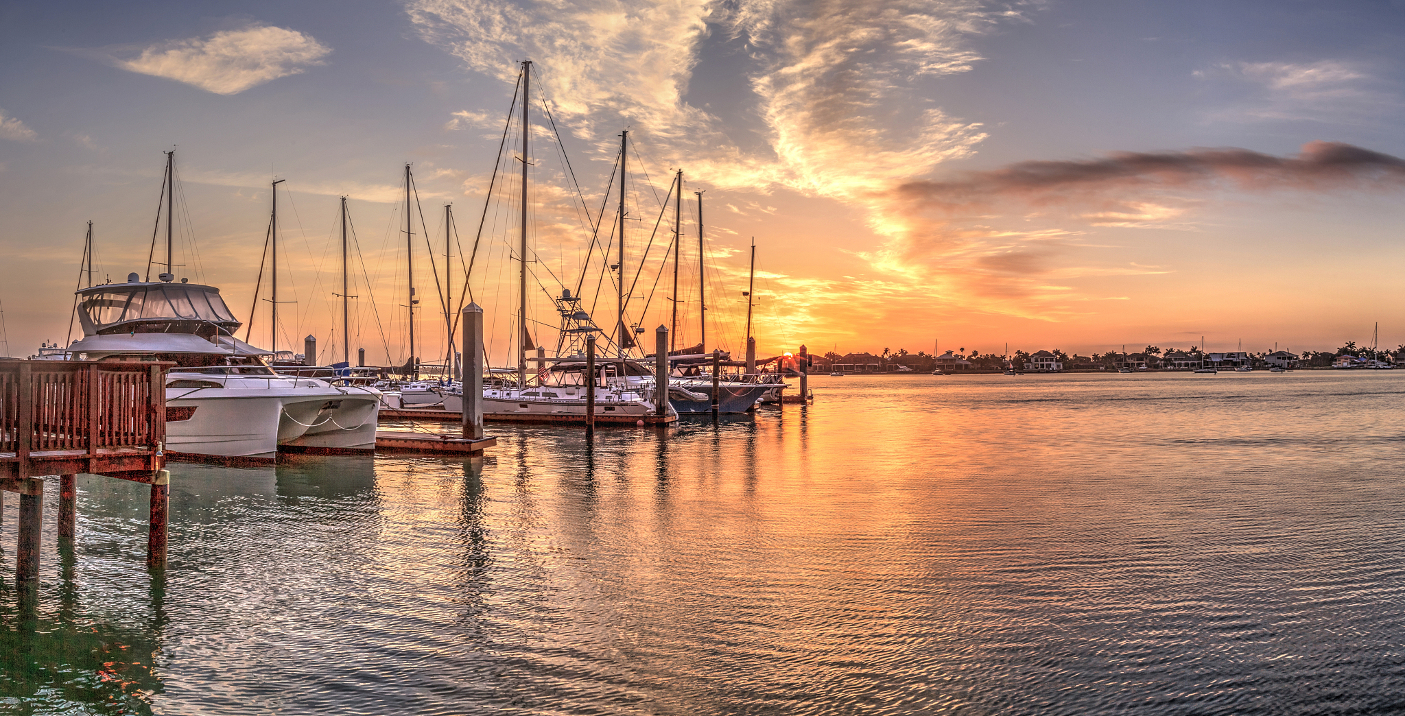 break of dawn sunrise over boats and sailboats at factory bay ma