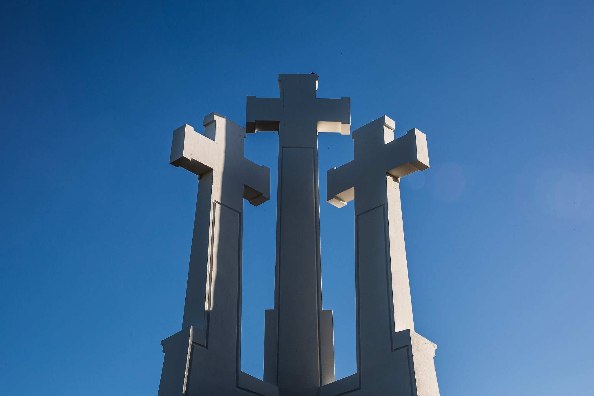 the three cross over blue sky