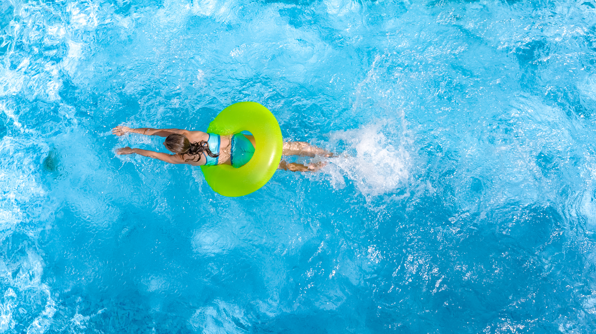 active young girl in swimming pool aerial top view from above, c
