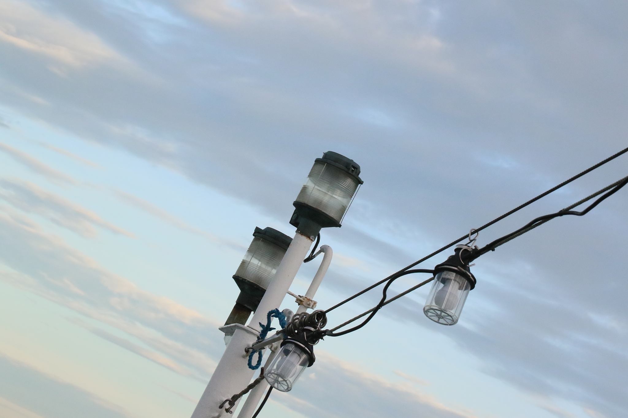 low angle view of telephone pole against cloudy sky