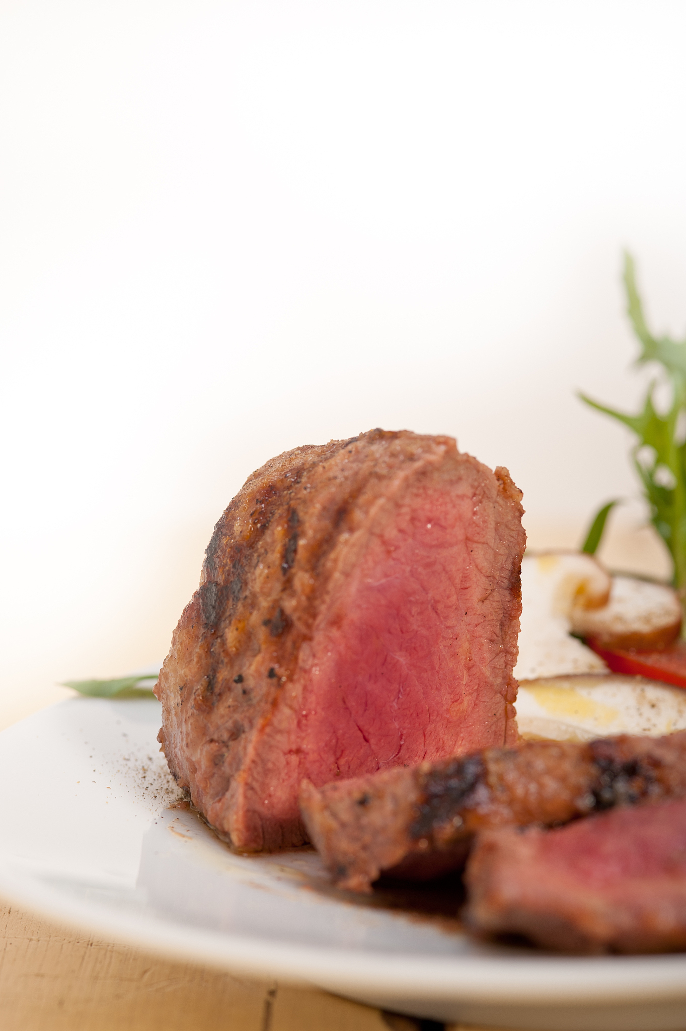 close-up of meat in plate against white background