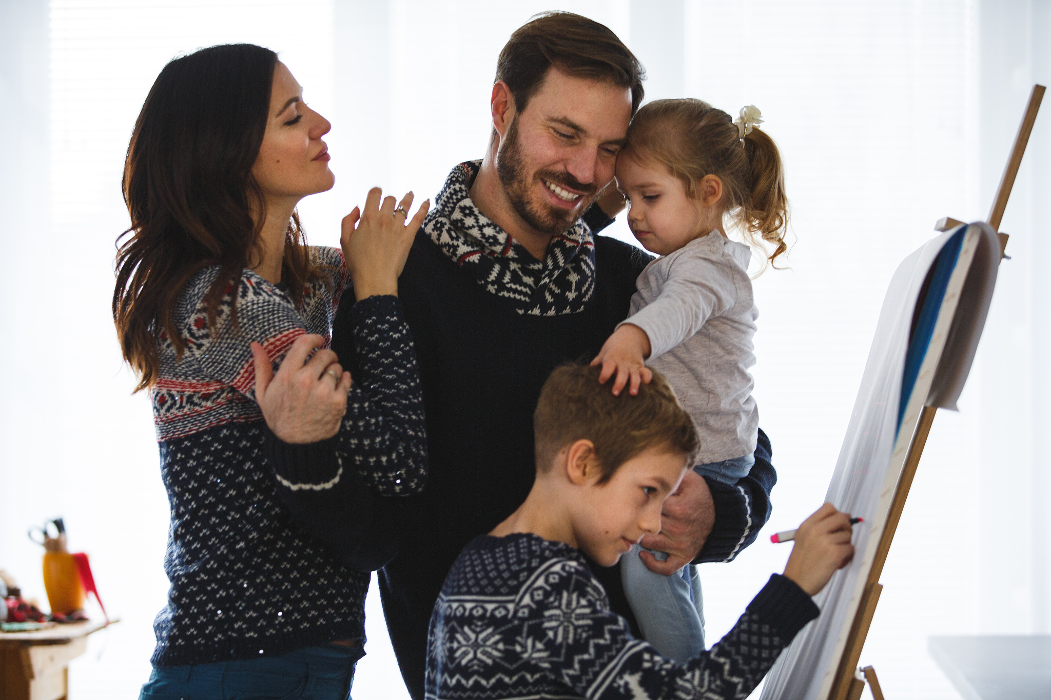 happy four members family spending time together at home