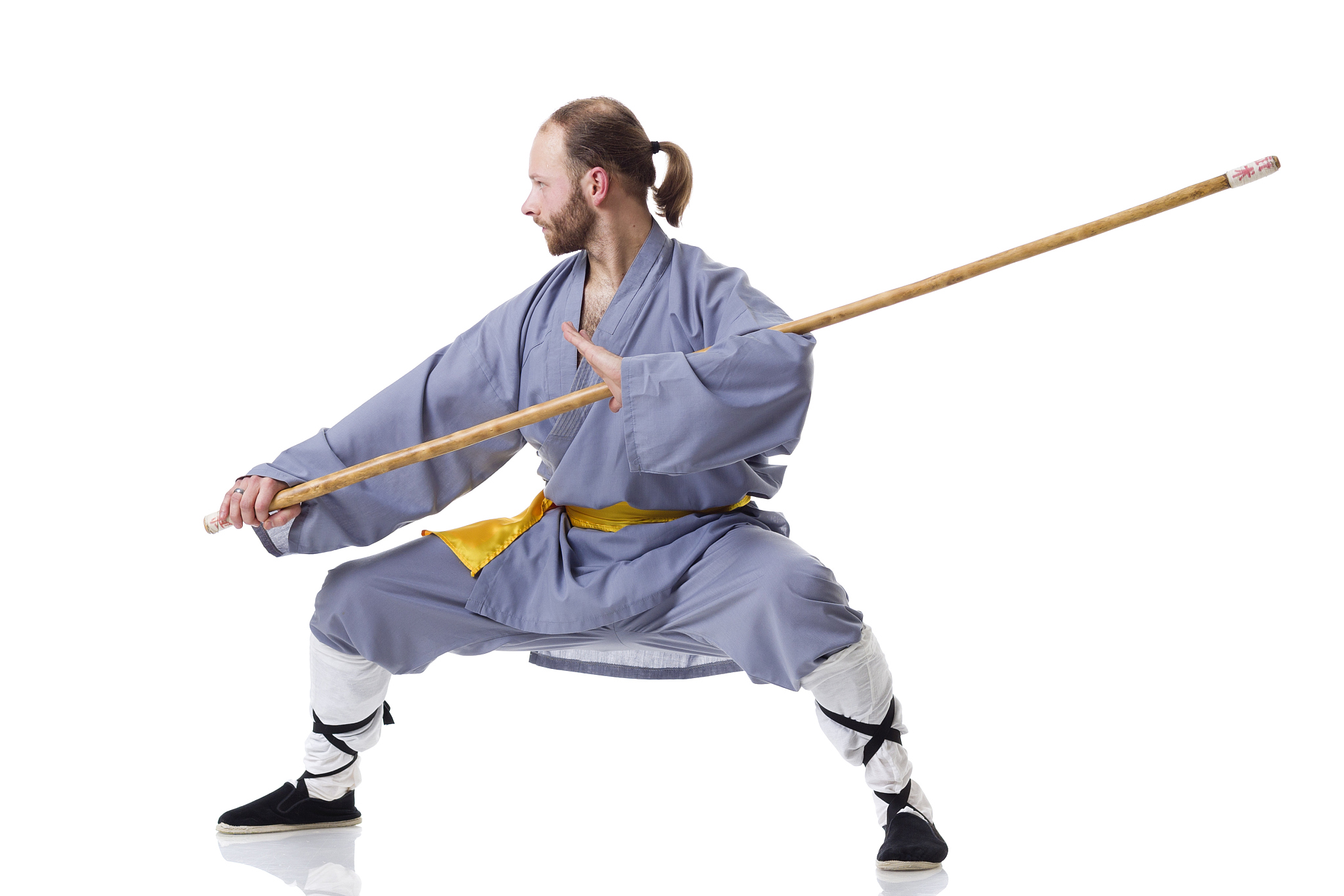 kung fu fighting position with wushu cudgel isolated on white
