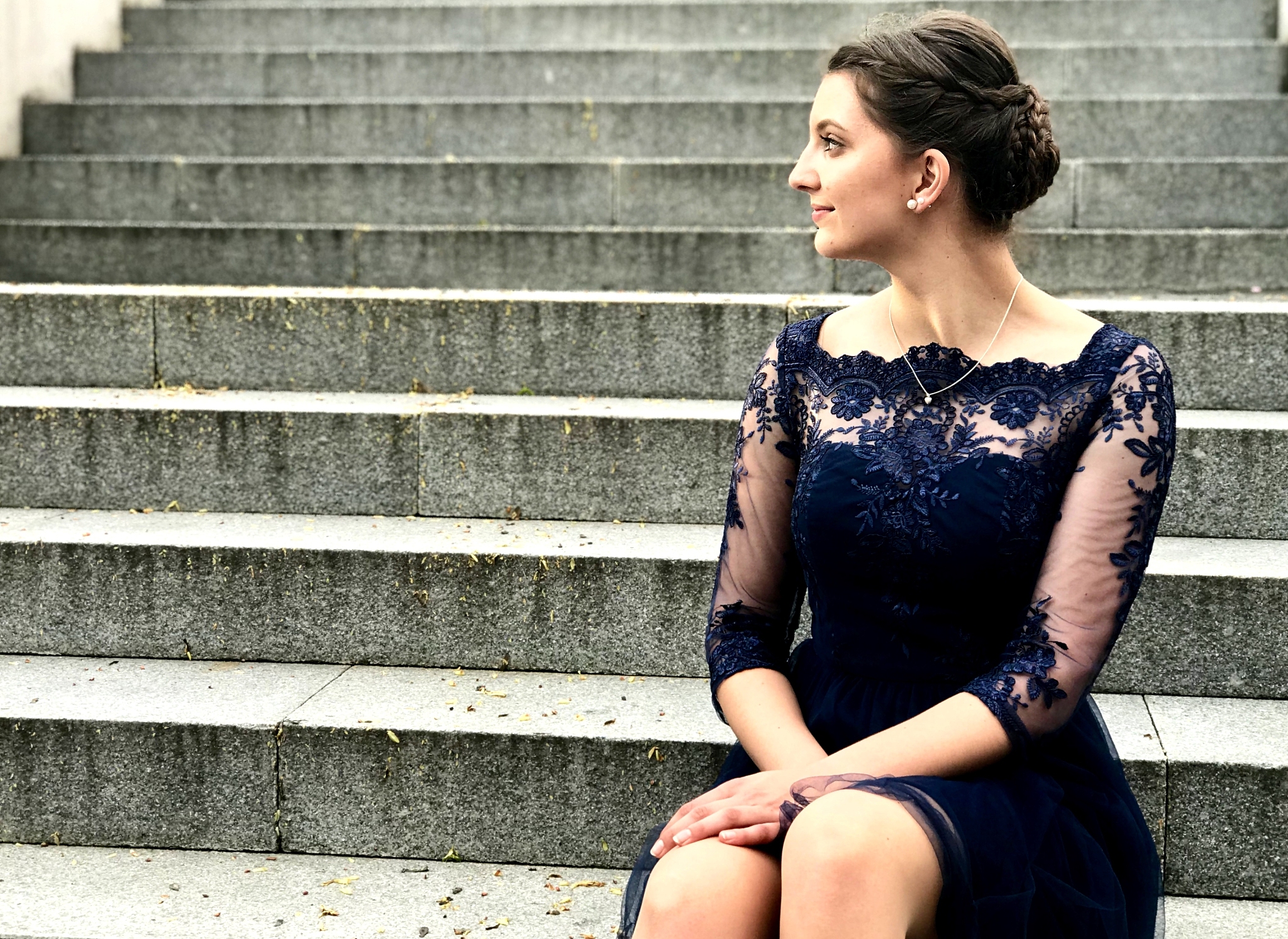 young woman sitting on staircase