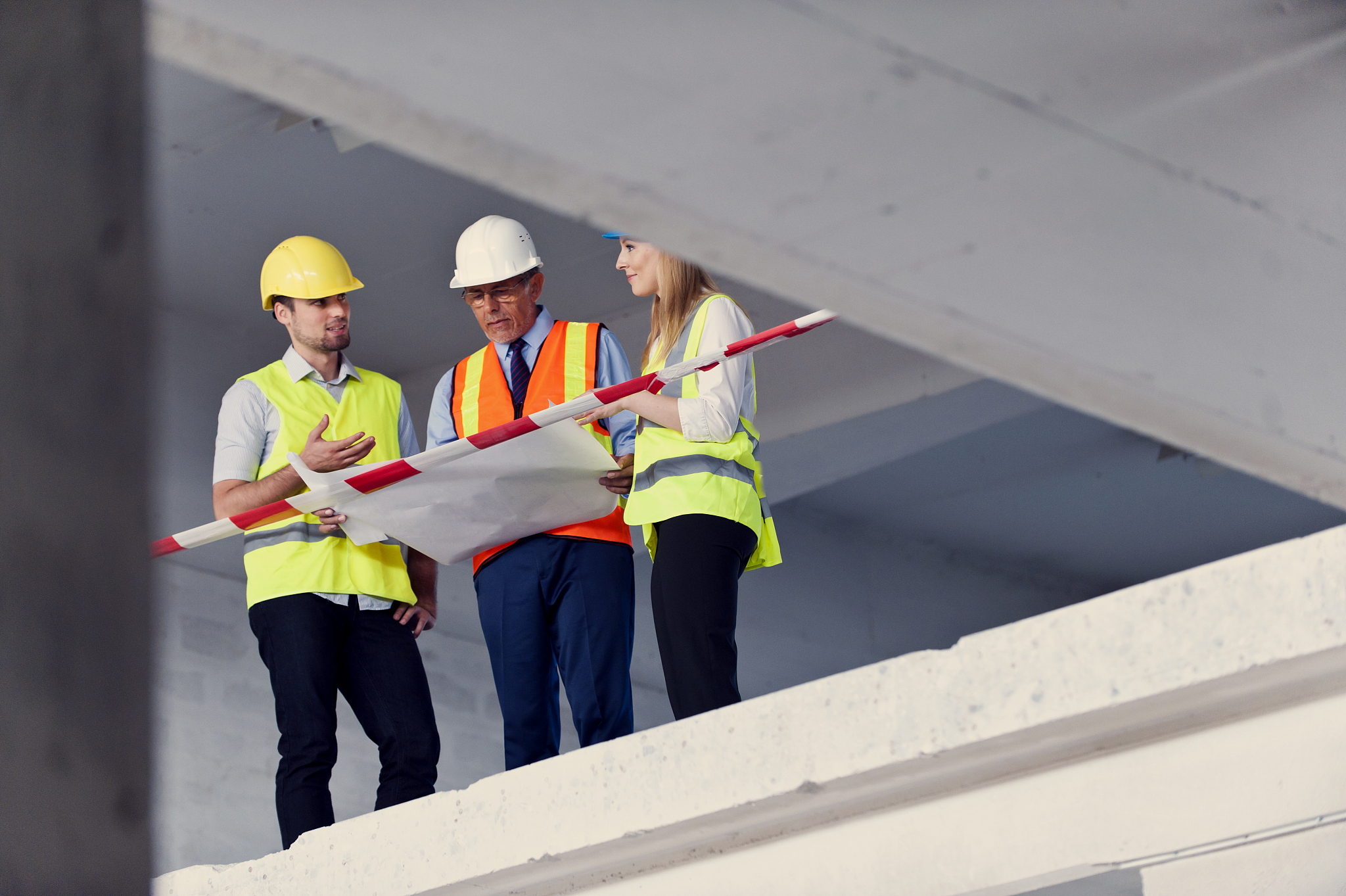 construction workers looking at blueprints