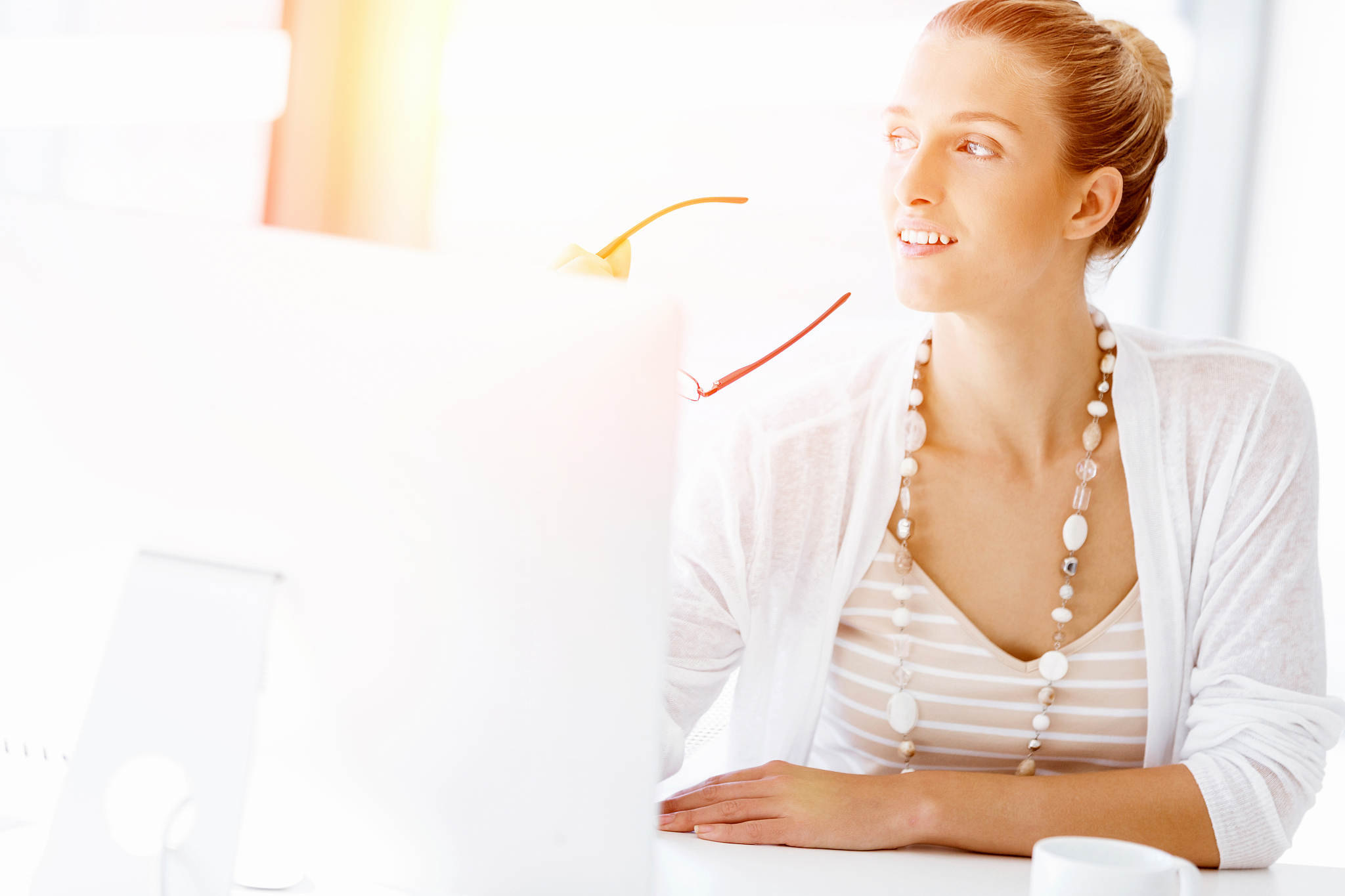 attractive office worker sitting at desk. attractive woman sitti