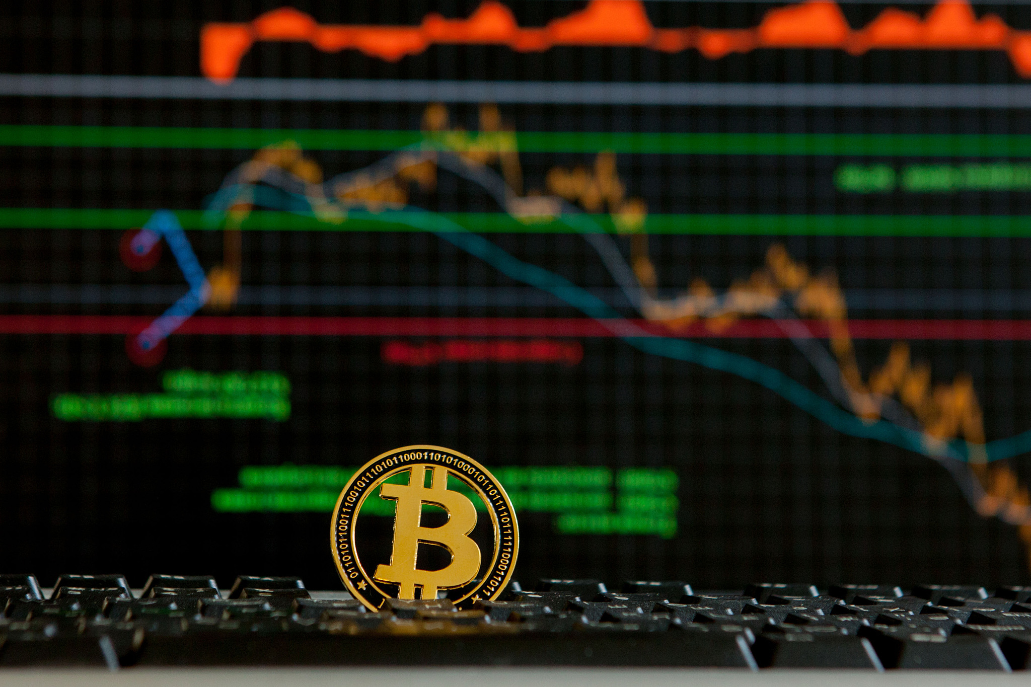 bitcoin gold coin and defocused chart background. virtual crypto