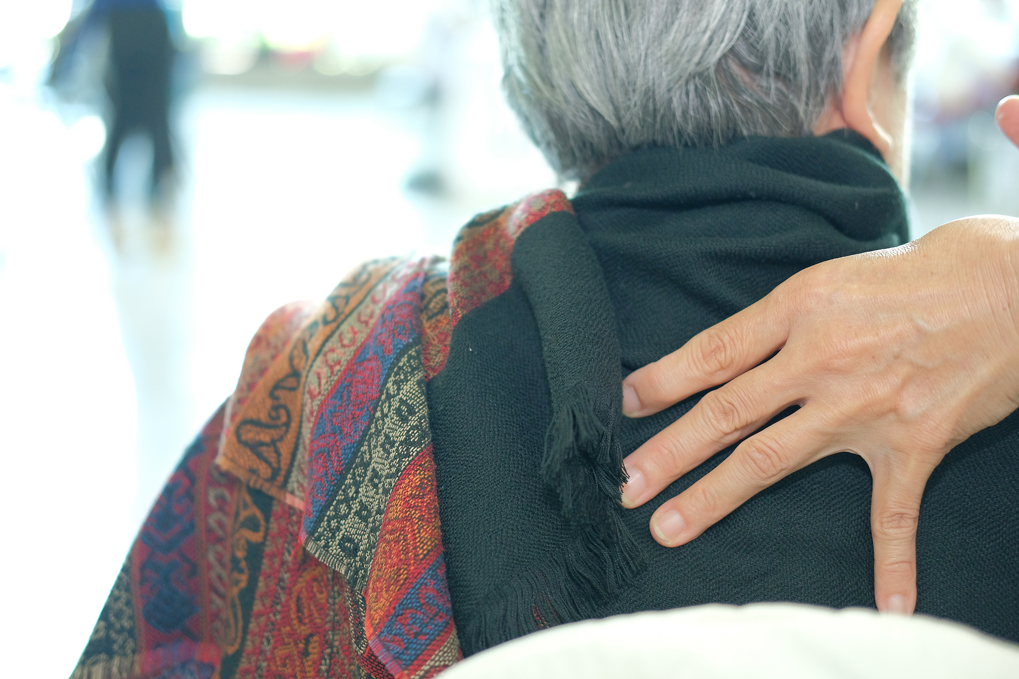 physiotherapist massage old woman shoulder