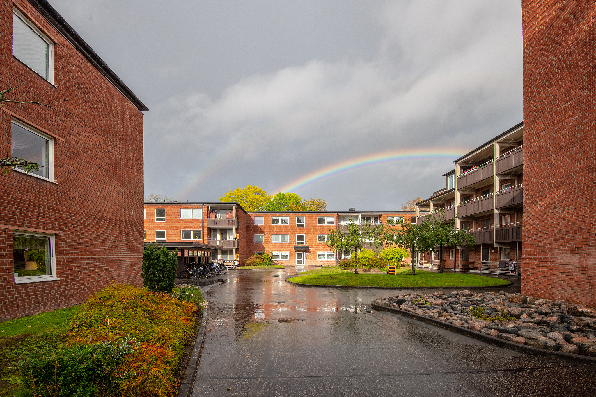 rainbow over a brick apartment complex..