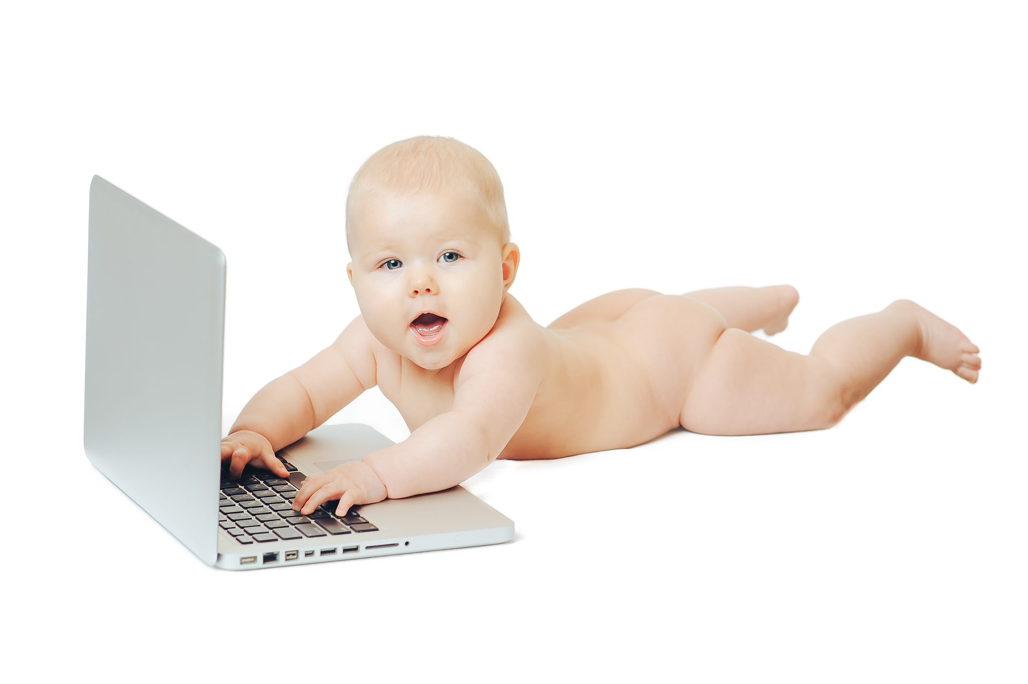 child sits in front of a laptop and push buttons