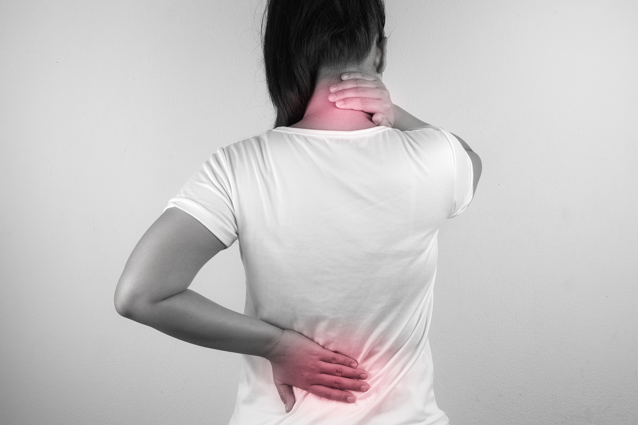 a woman feeling exhausted and suffering from neck and back pain 