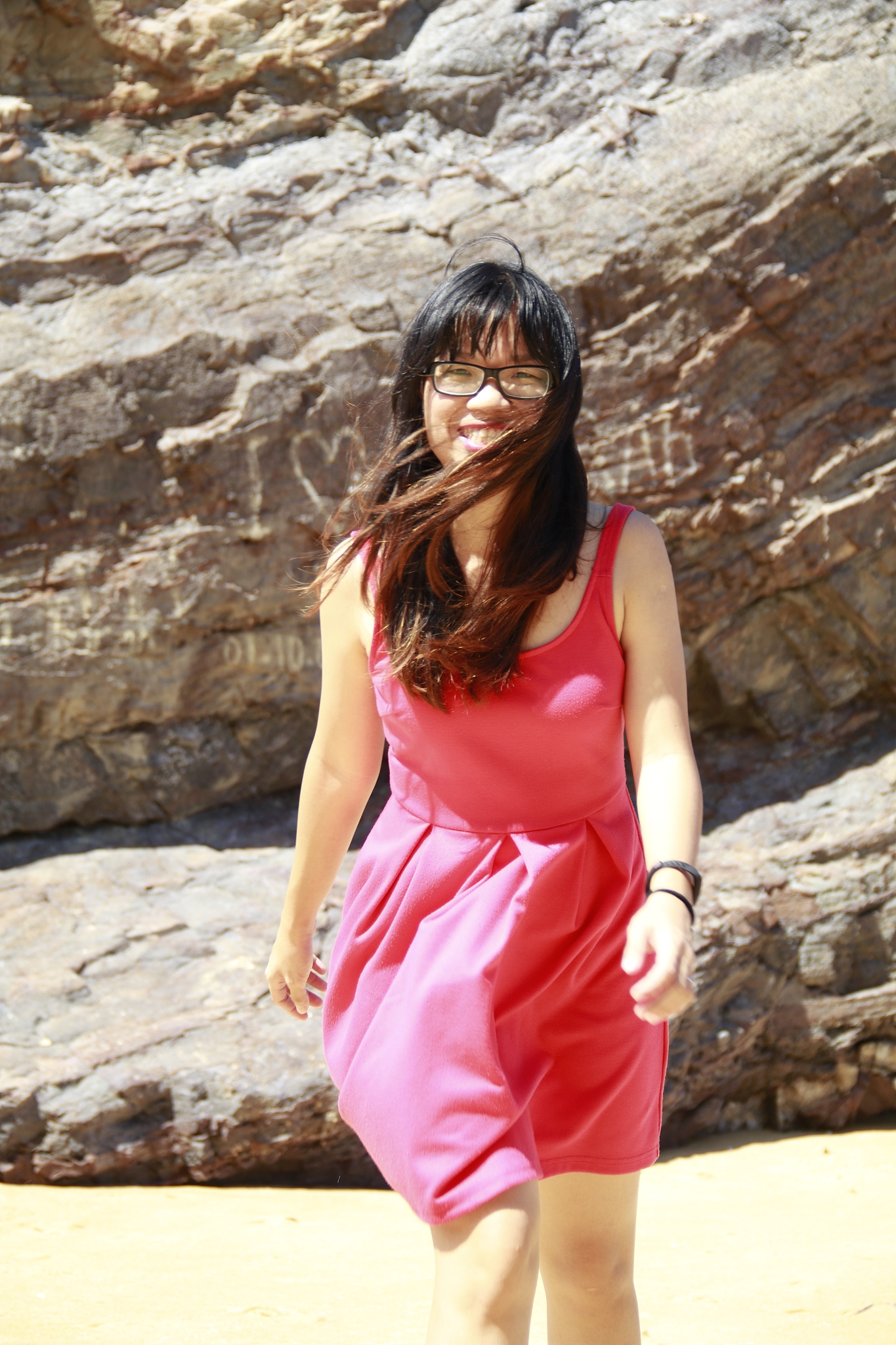 beautiful woman standing against rock