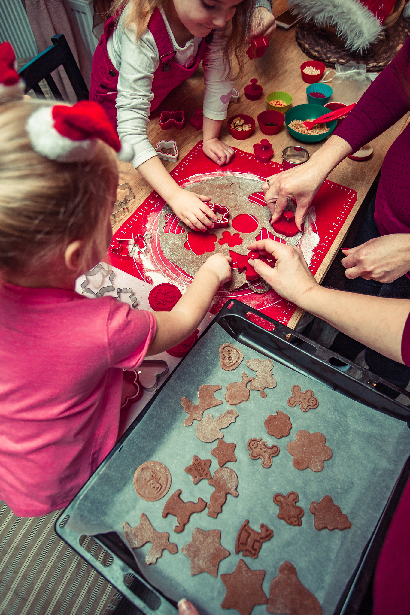 woman preparing food with children at home