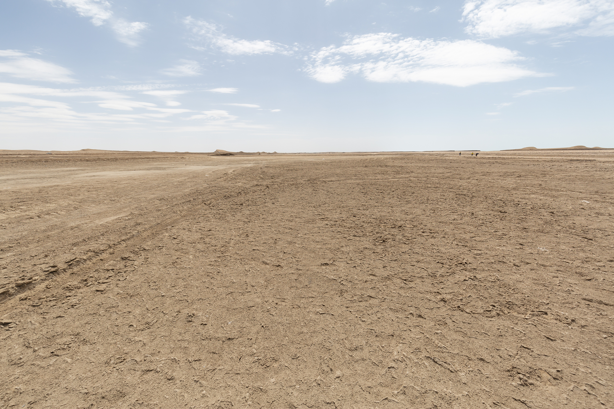 cracked land with arid mountains