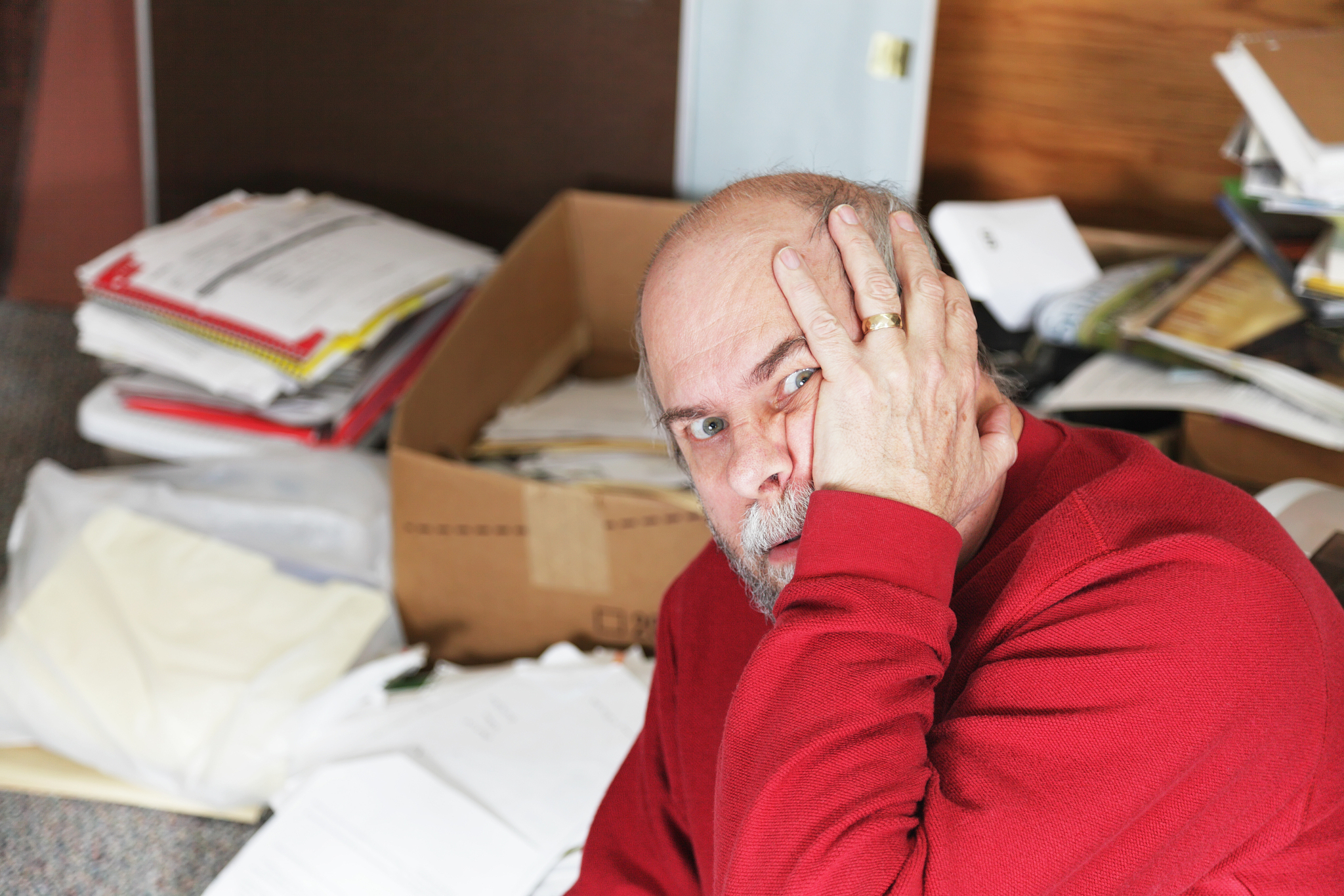 married add man upset with messy papers and boxes