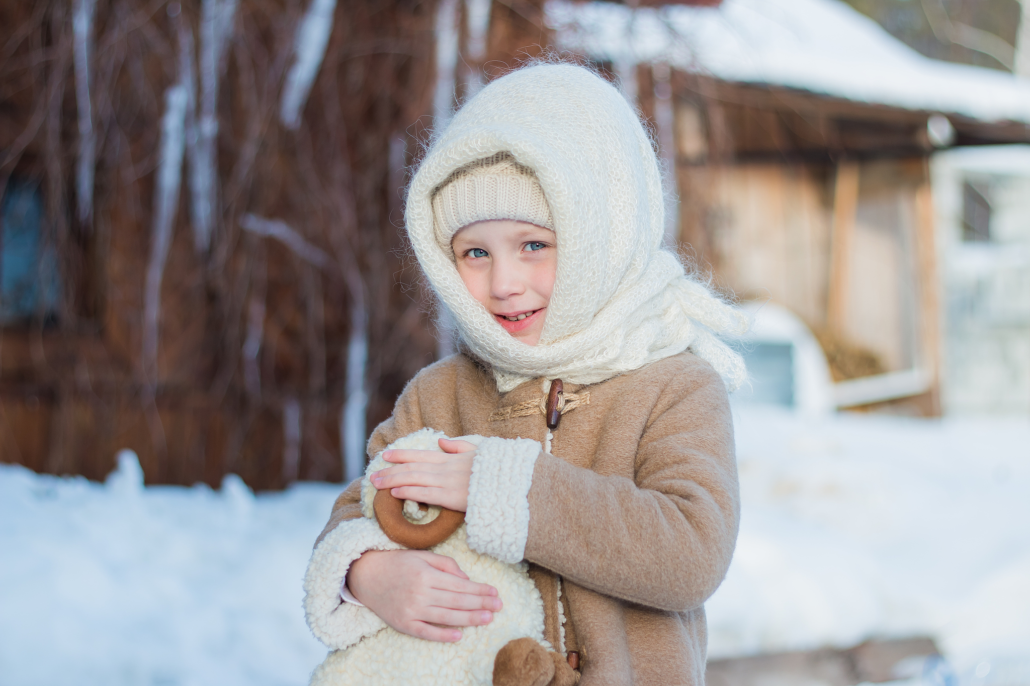 girl in russian scarf on the head with his favorite toy on a fro