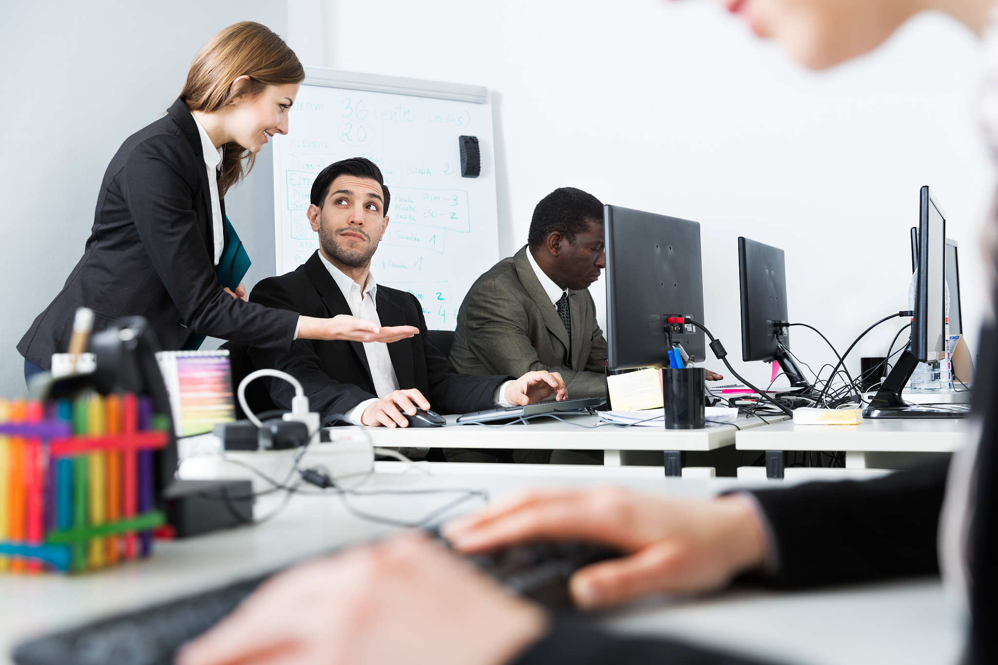 coworkers having fun conversation and flirting in office
