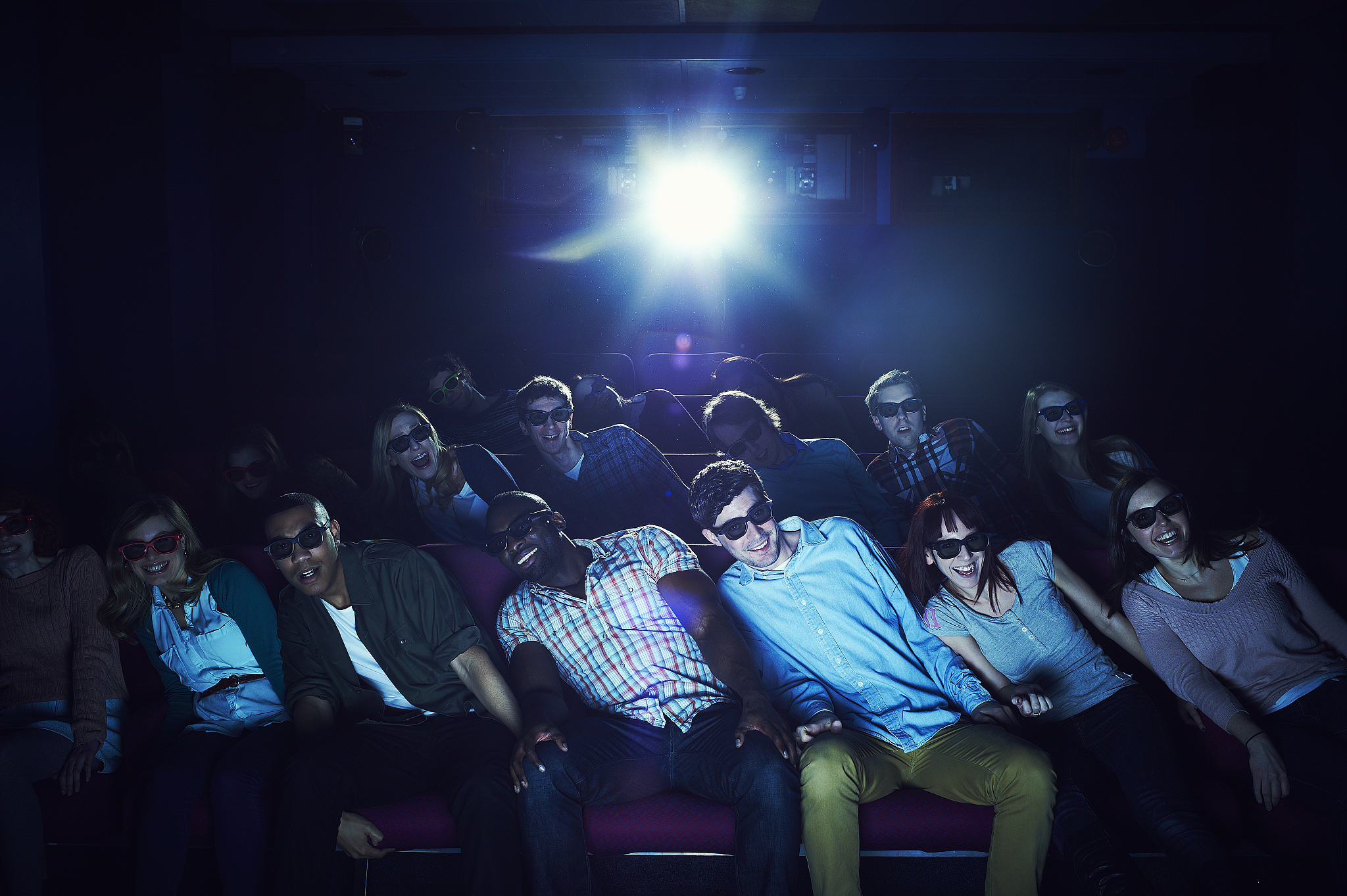 group of people wearing 3d glasses at the movies
