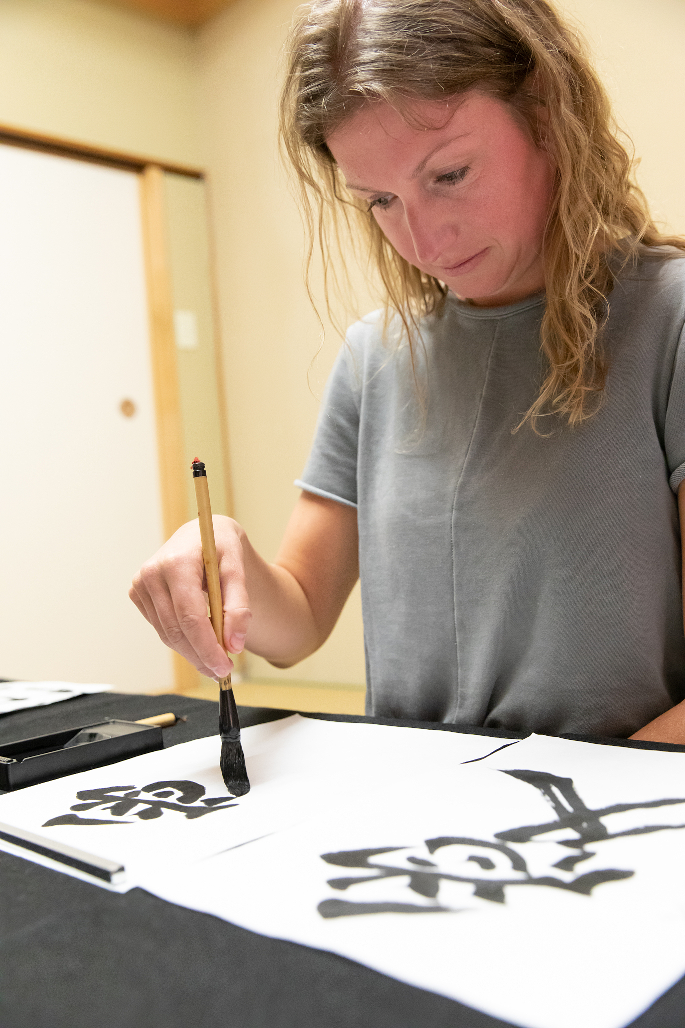 foreign people learning japanese calligraphy