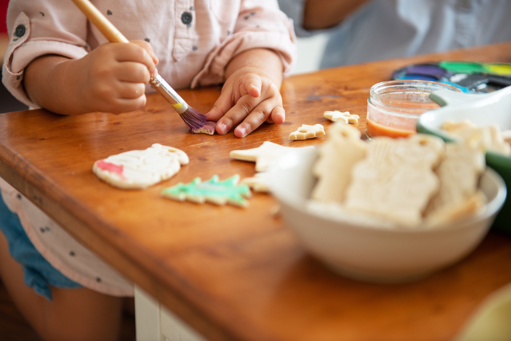 mother and daughter painting christmass ornaments
