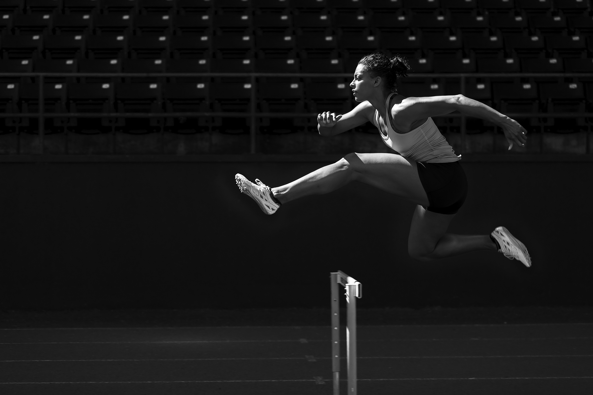 a runner taking on the hurdles.